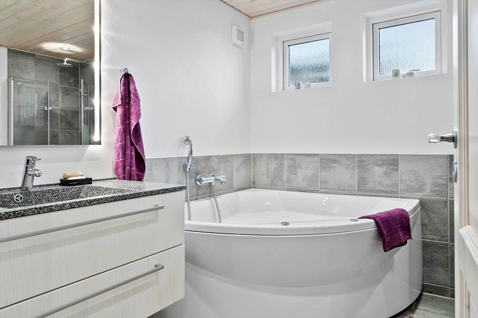 Badezimmer mit Badewanne, Waschbecken und Dusche
