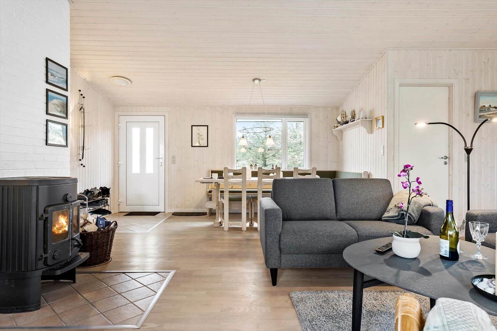 Living and dining area with fireplace, sofa, and table