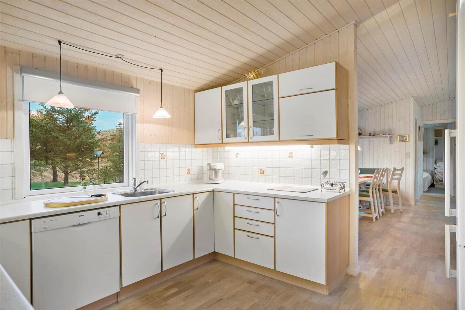 Kitchen with window, sink, dishwasher, and worktop
