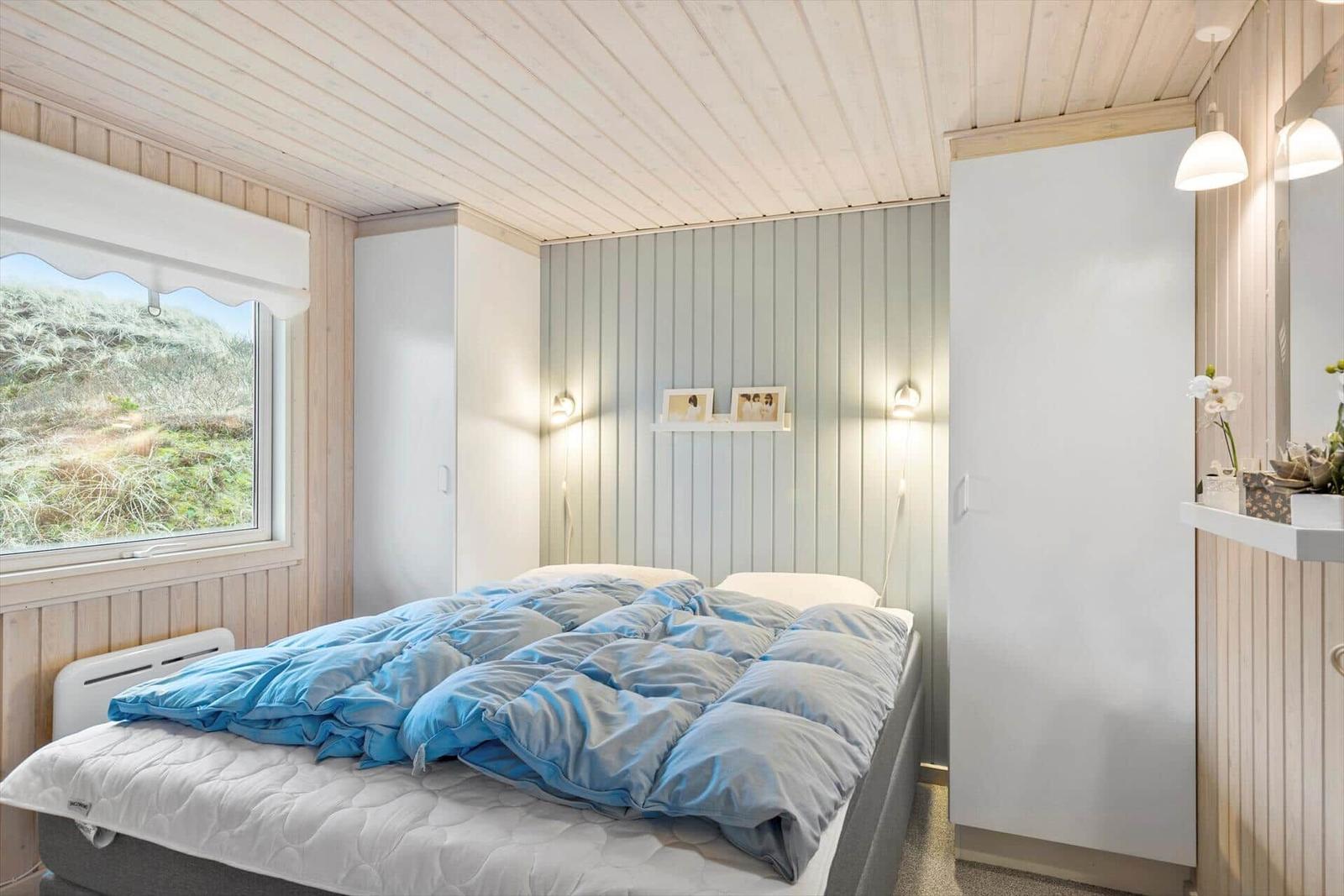 Bedroom with bed, window, and closets