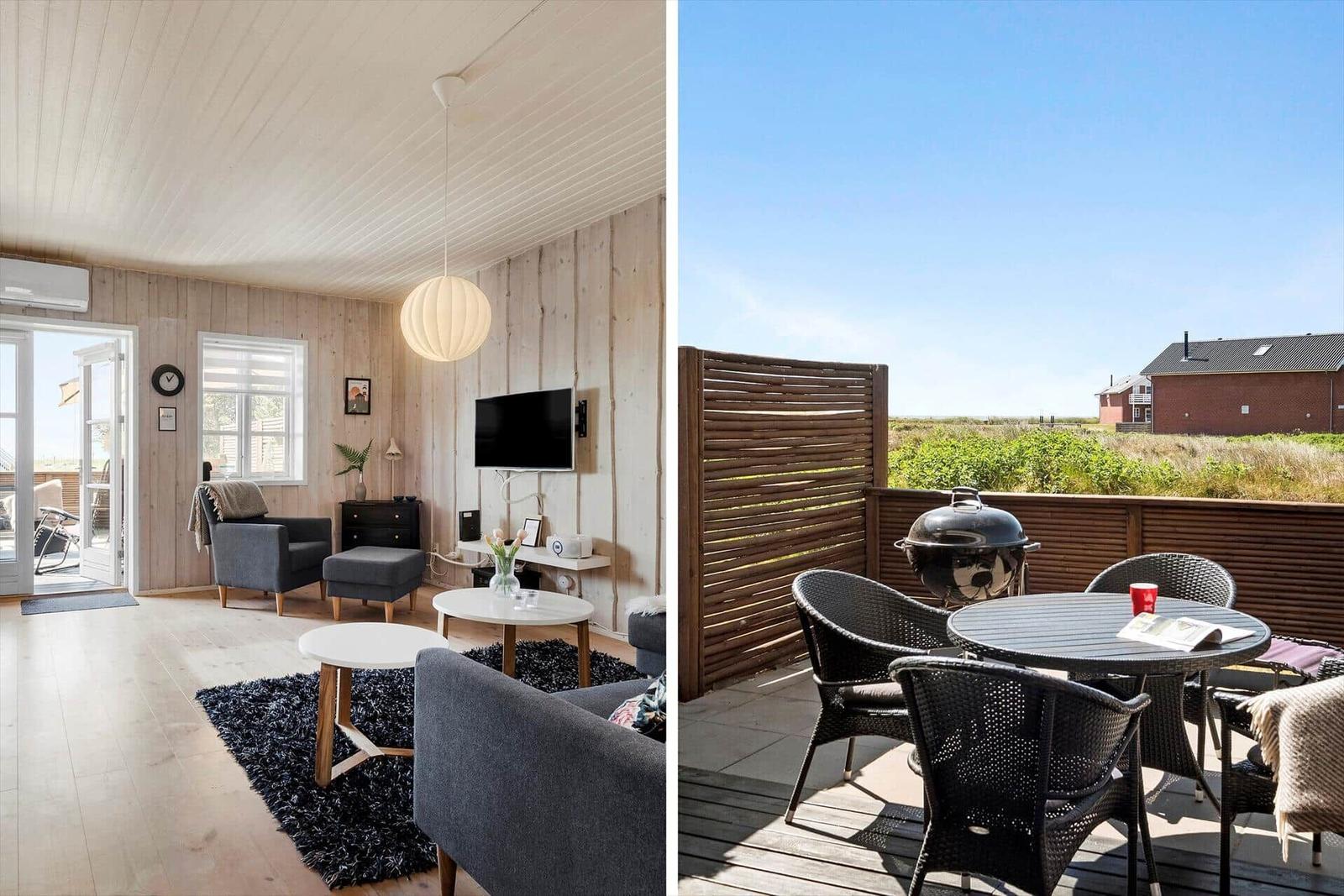 Living room with wooden walls and balcony with grill and seating group.