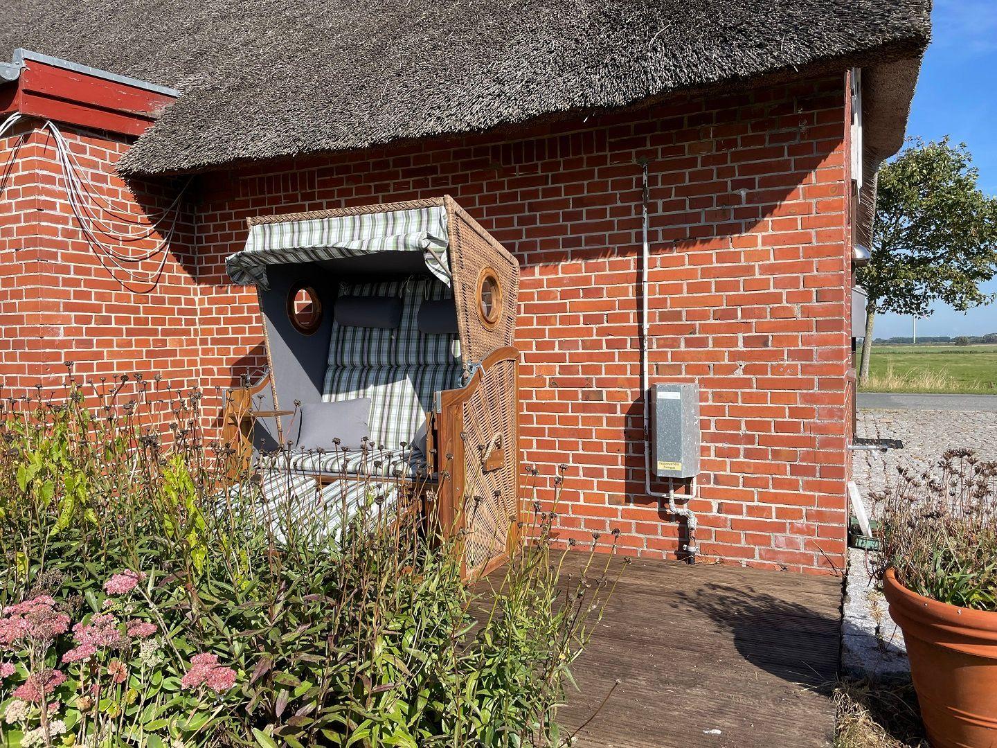 House with thatched roof and wicker sunshade