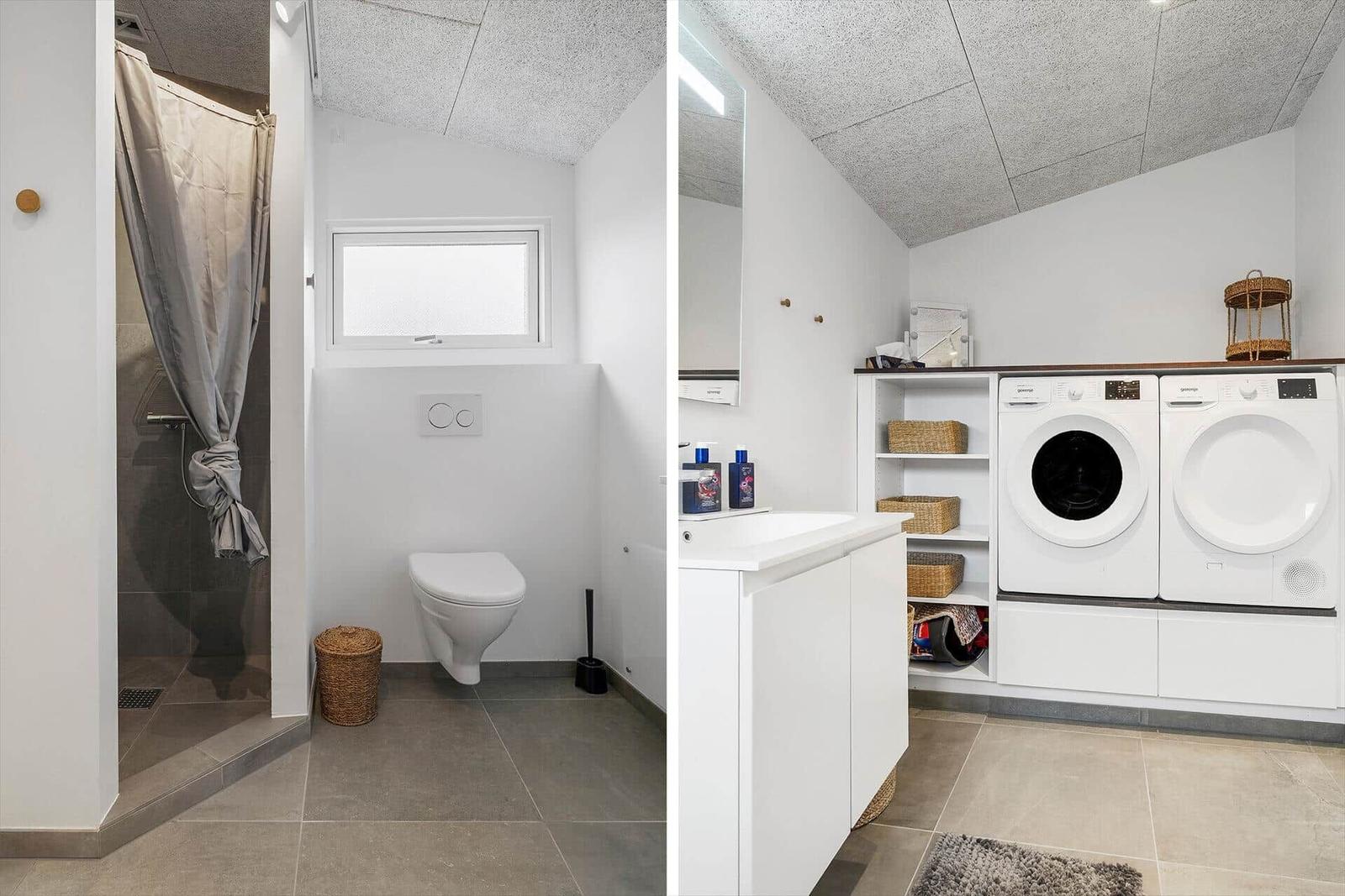 Badezimmer mit Dusche und Toilette. Nebenraum mit Waschmaschine und Trockner.