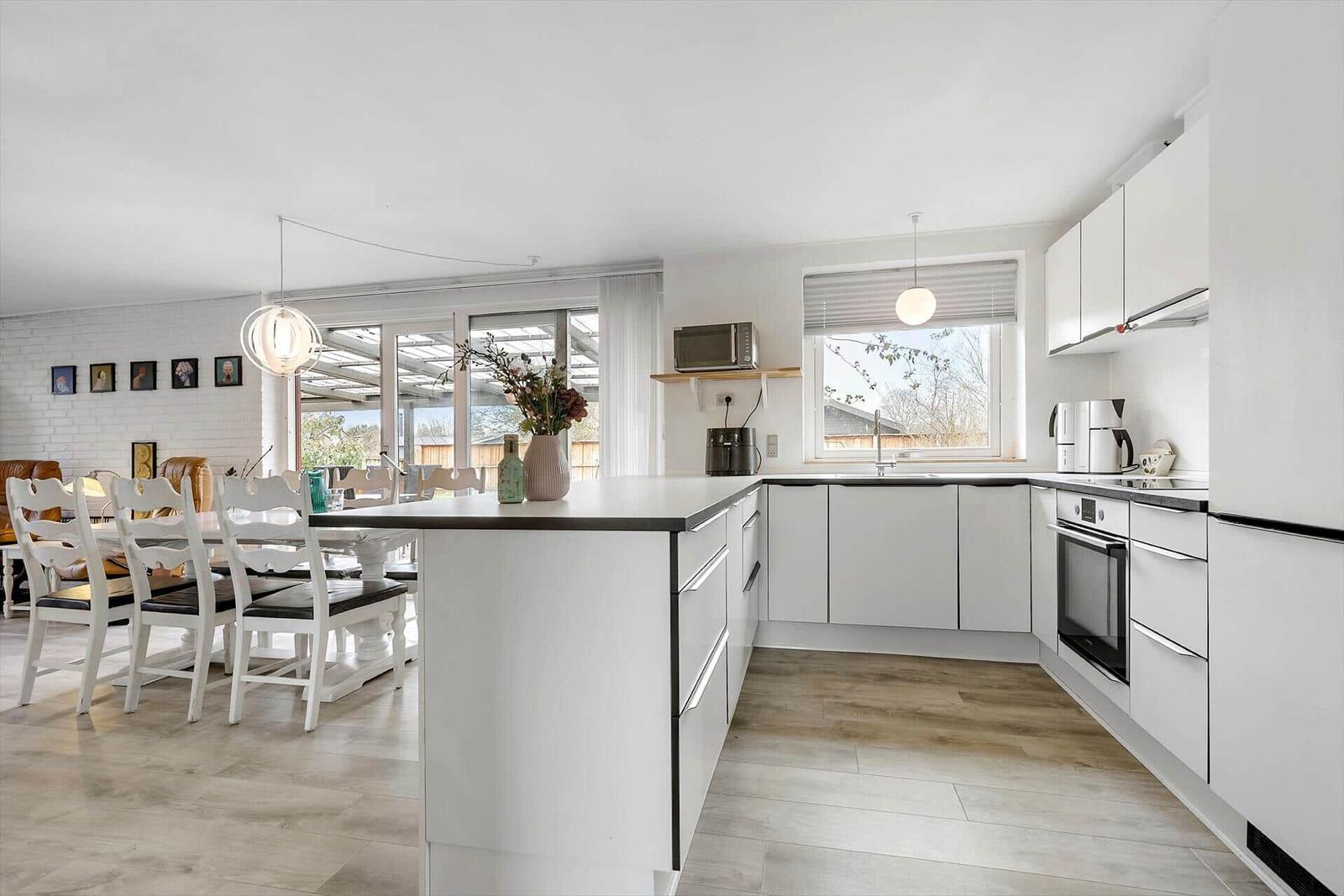 Modern kitchen with dining area and garden view
