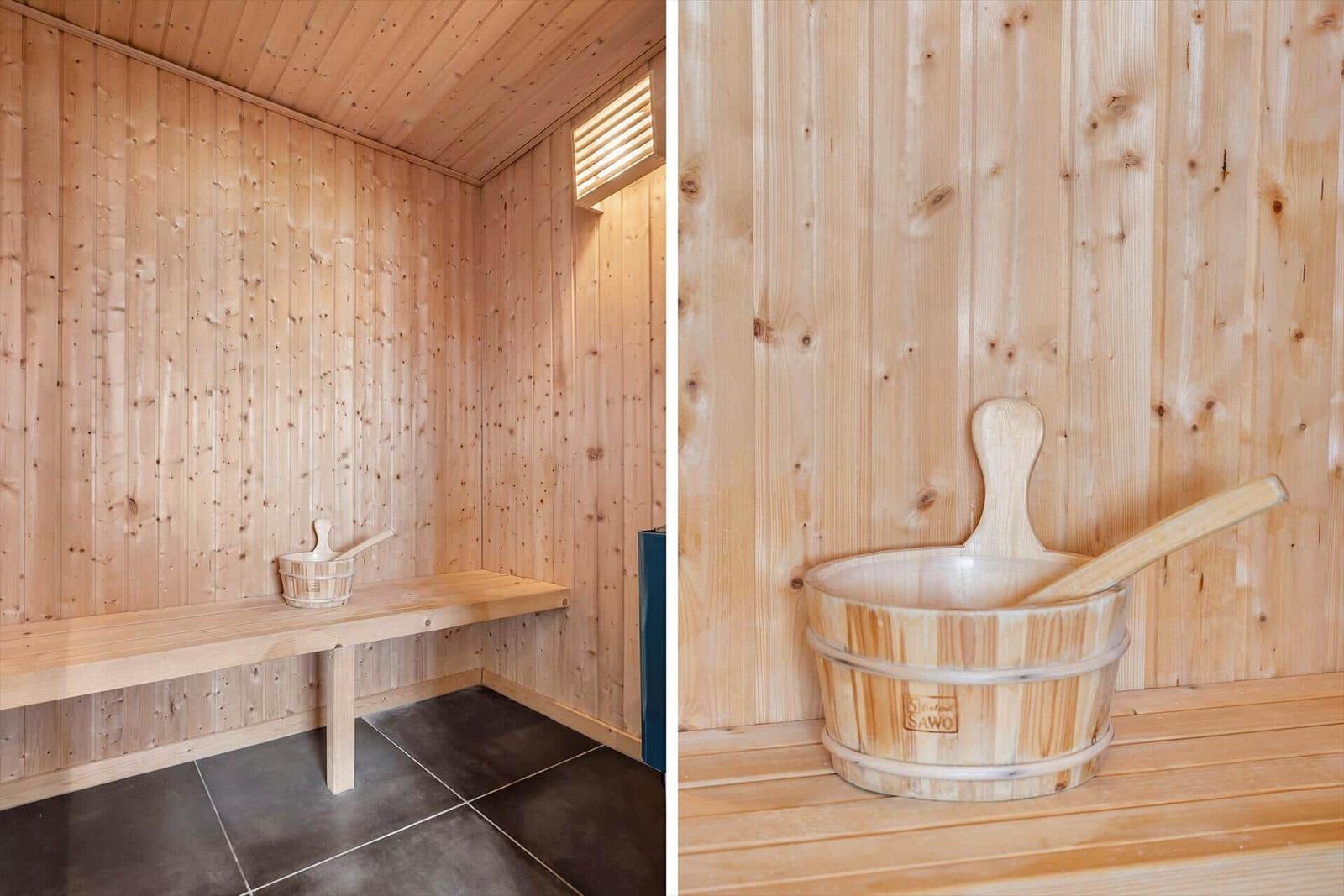 Sauna with wooden bench and wooden bucket with ladle