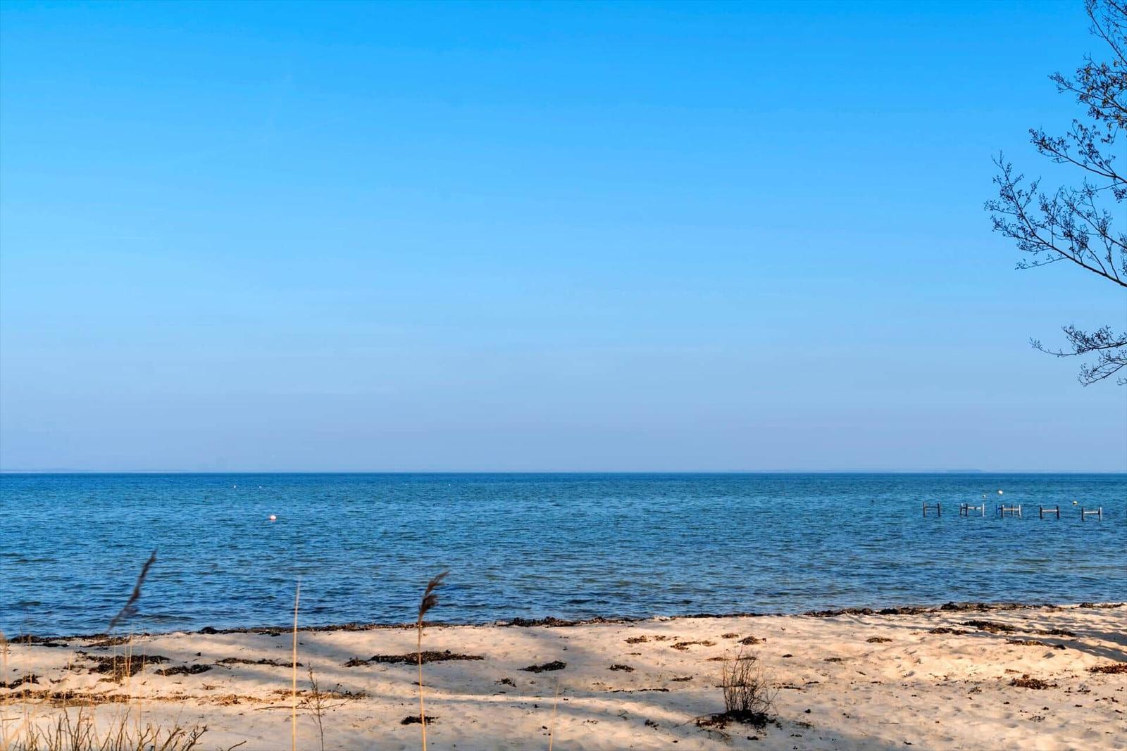 Beach with sand and sea under blue sky