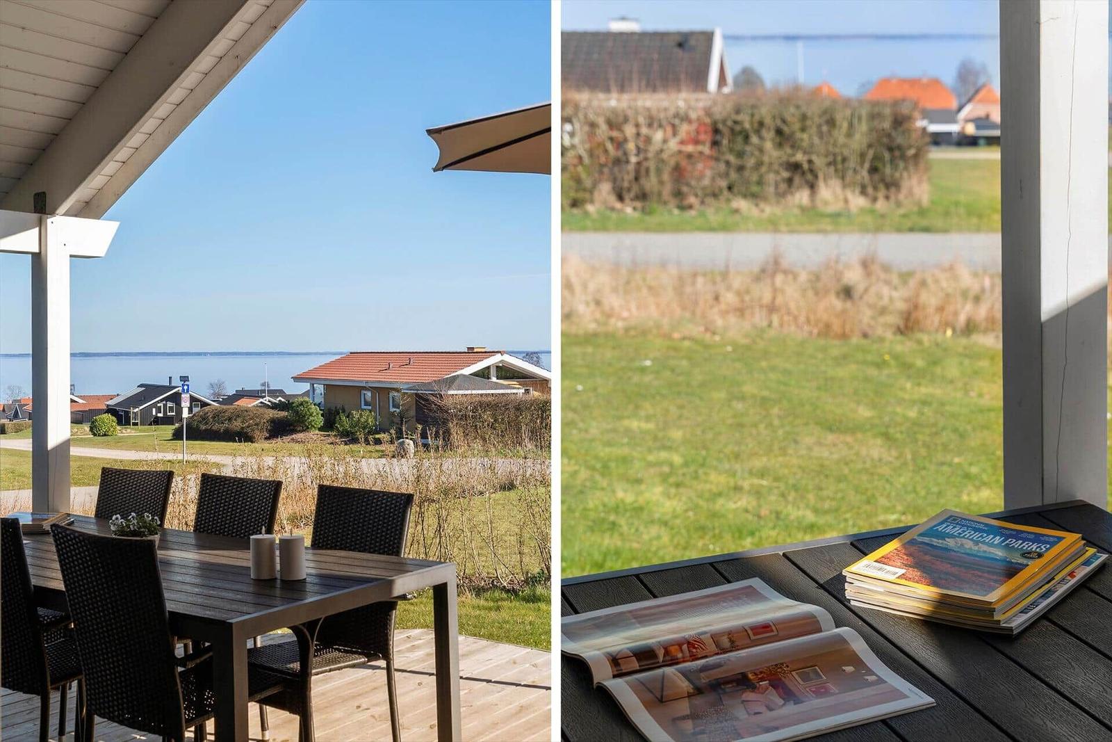 Terrace with table and chairs, view of water and houses. Table with magazines.