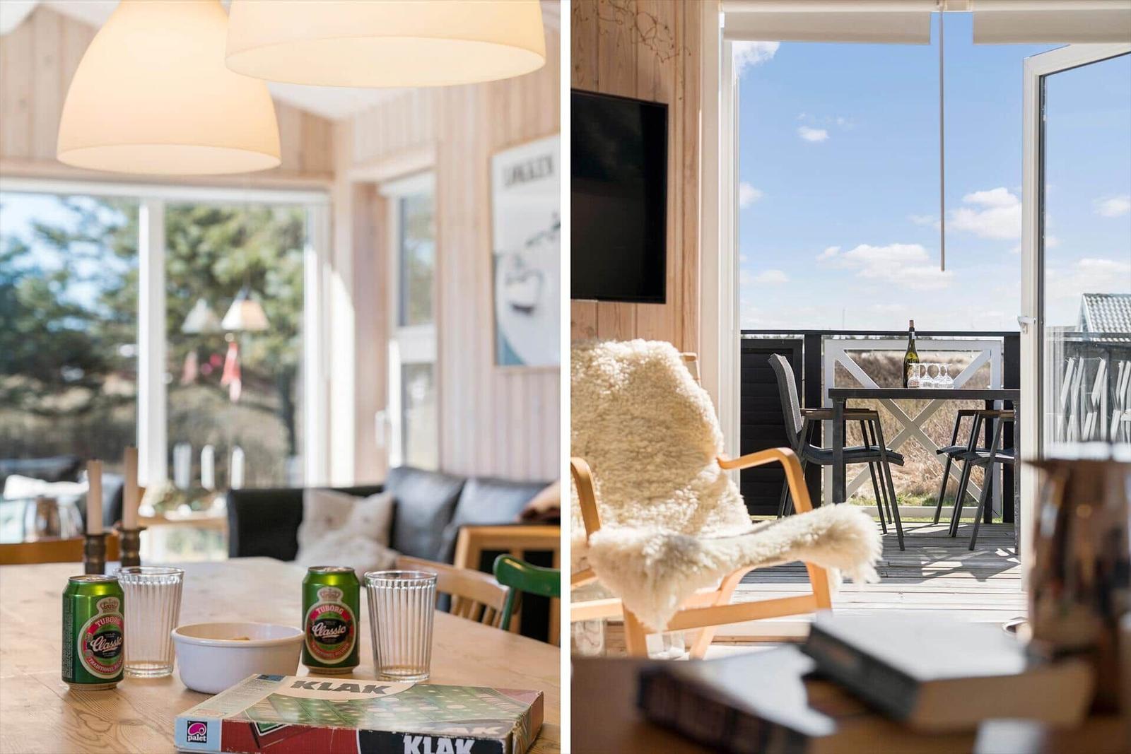 Essbereich mit Tisch und Getränken. Terrasse mit Sitzgelegenheiten und Aussicht.