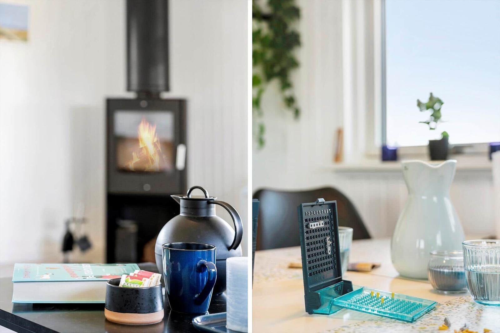 Fireplace with flame, table with kettle and mug, table with grater and water glass.