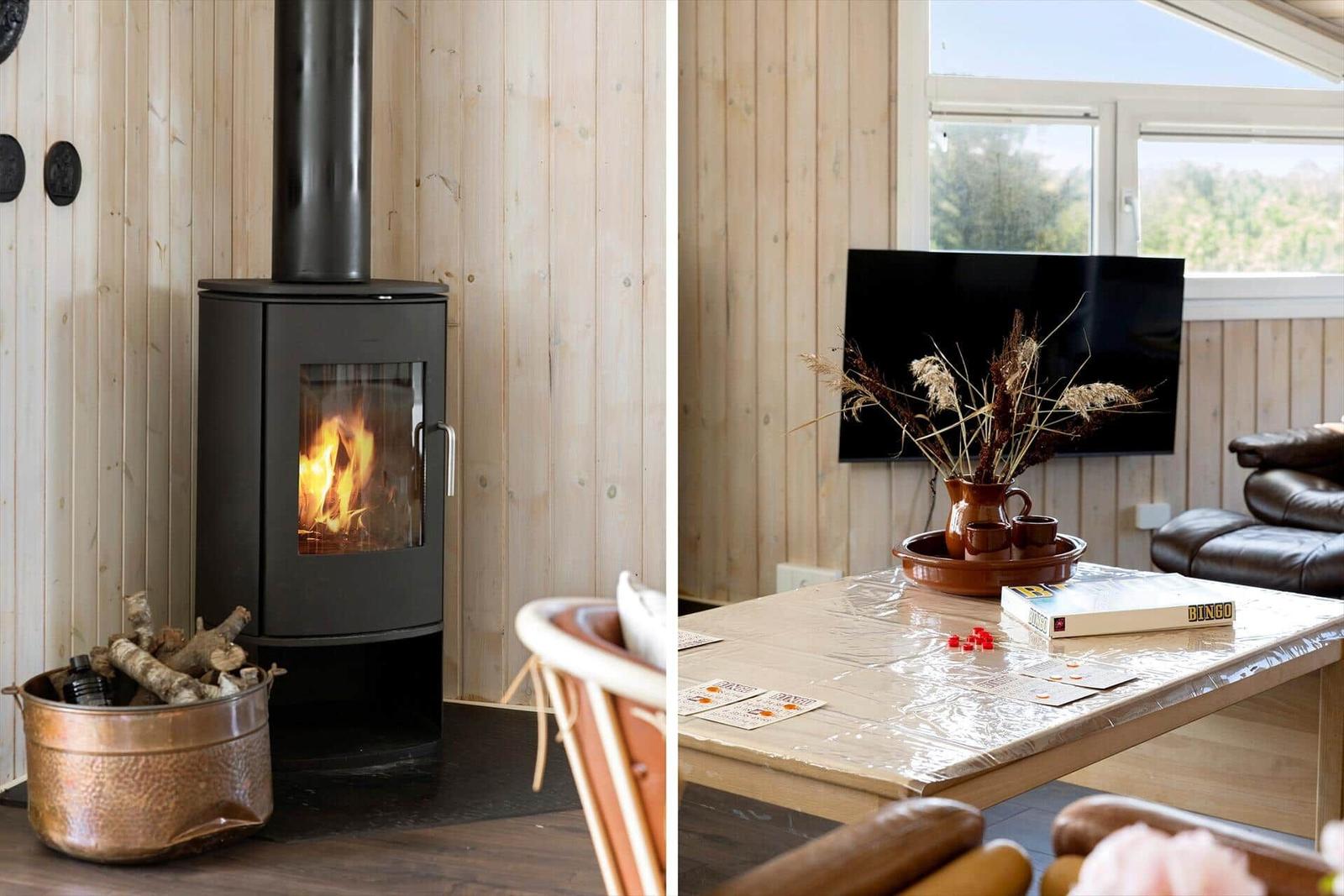 Kaminofen mit Brennholz und Wohnzimmer mit Fernseher und Tisch.