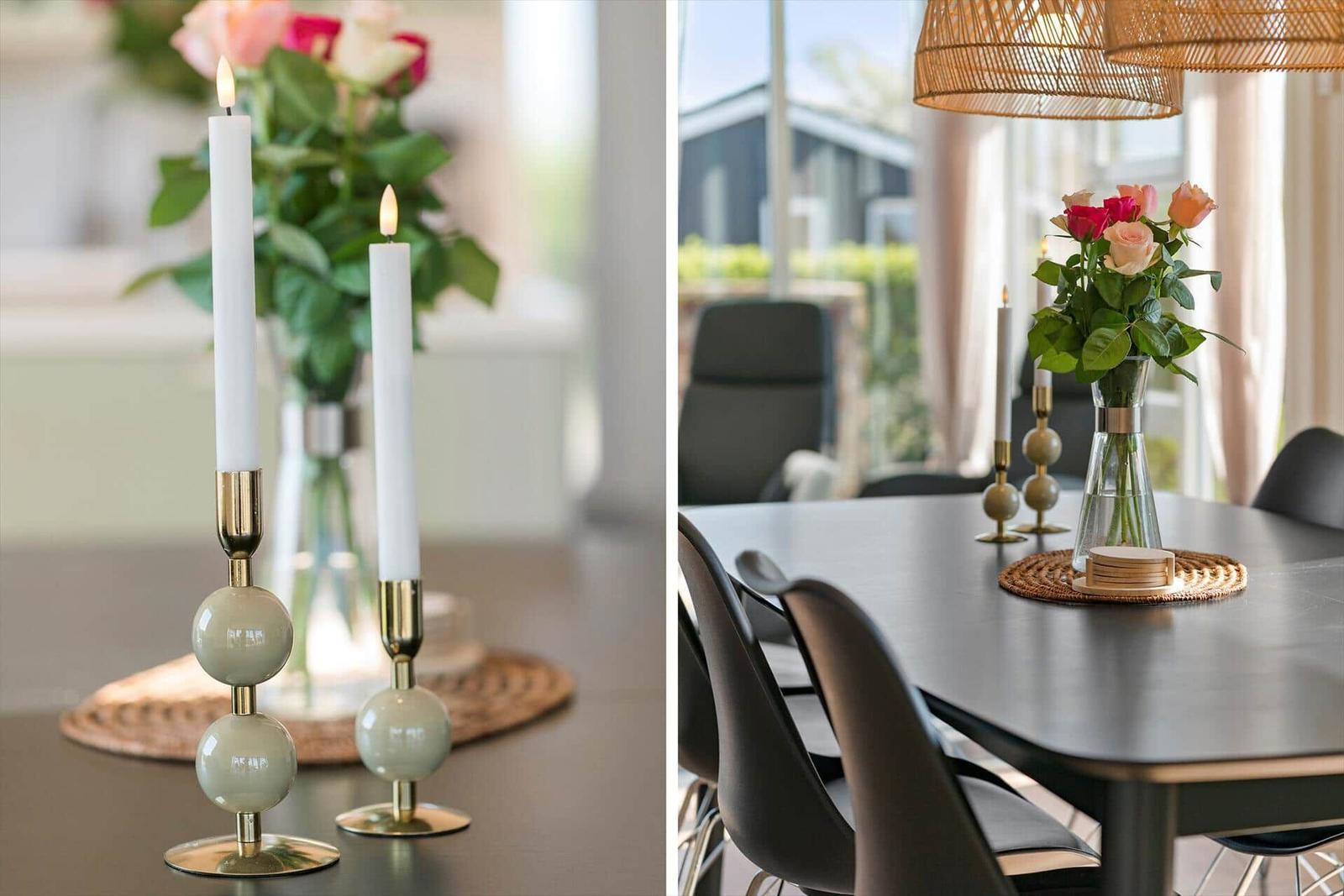 Dining table with candle holders and flower arrangement