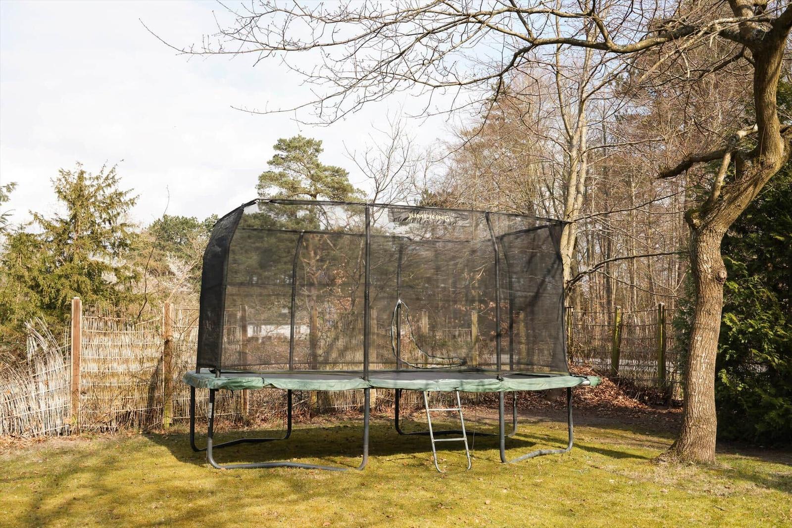 Large trampoline with safety net in the garden