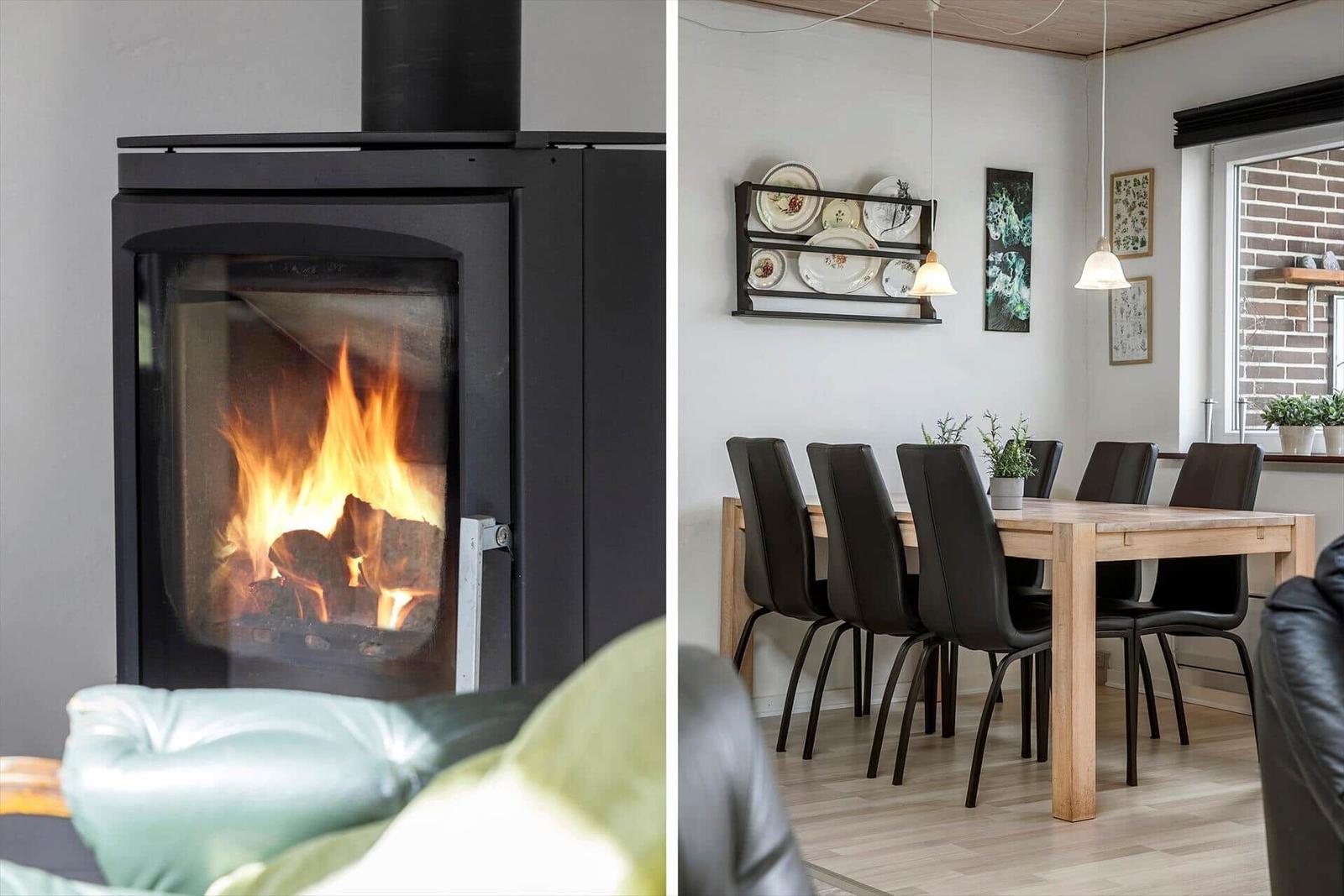 Fireplace with burning wood and dining room with table and chairs.