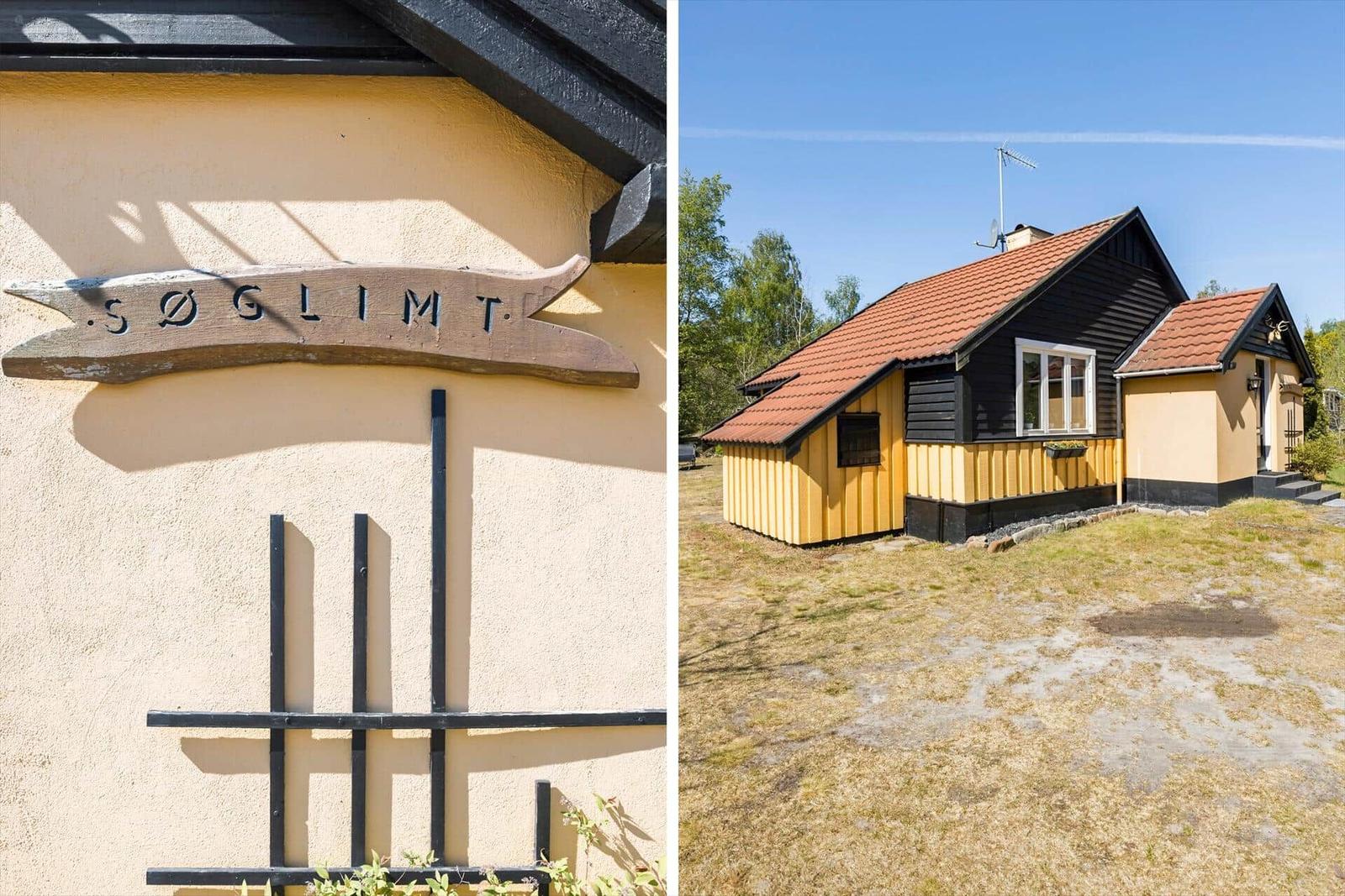 Haus mit gelbem und schwarzem Holzverkleidung und rotem Dach