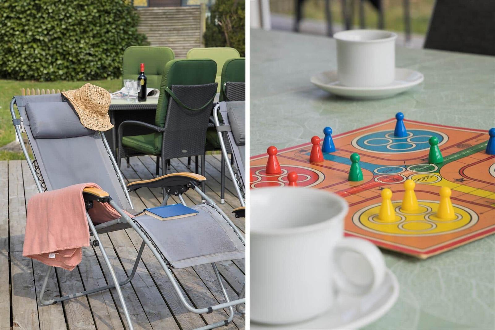 Deck with lounge chair, table, and game board with pieces.