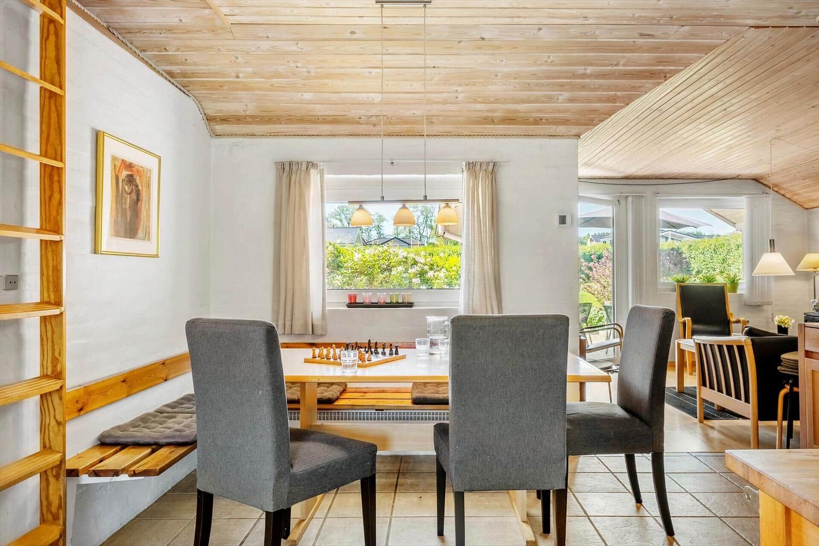 Dining area with table, chairs, and view of garden