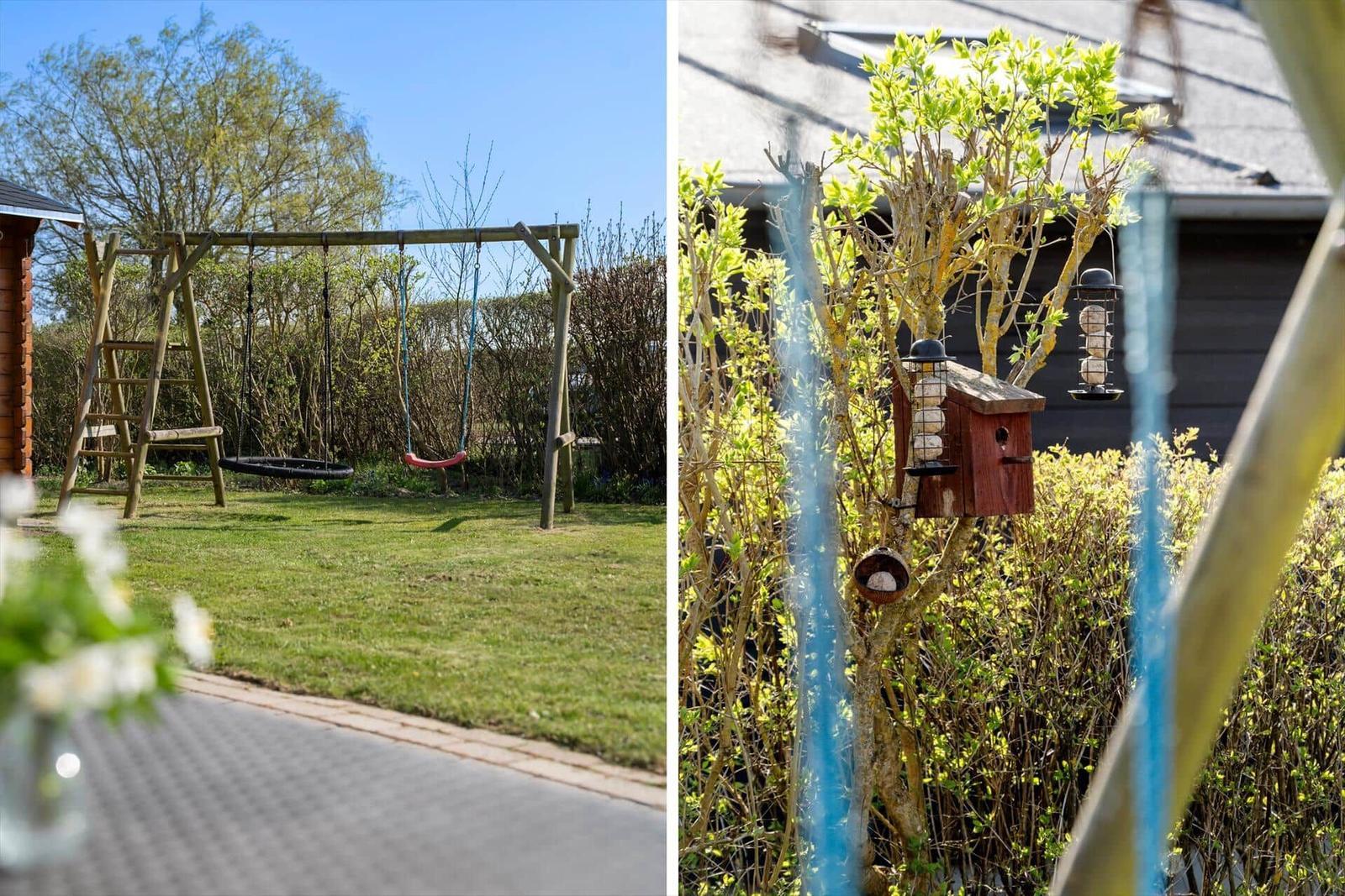 Backyard with swing and playset. Garden with birdhouse and feeders.