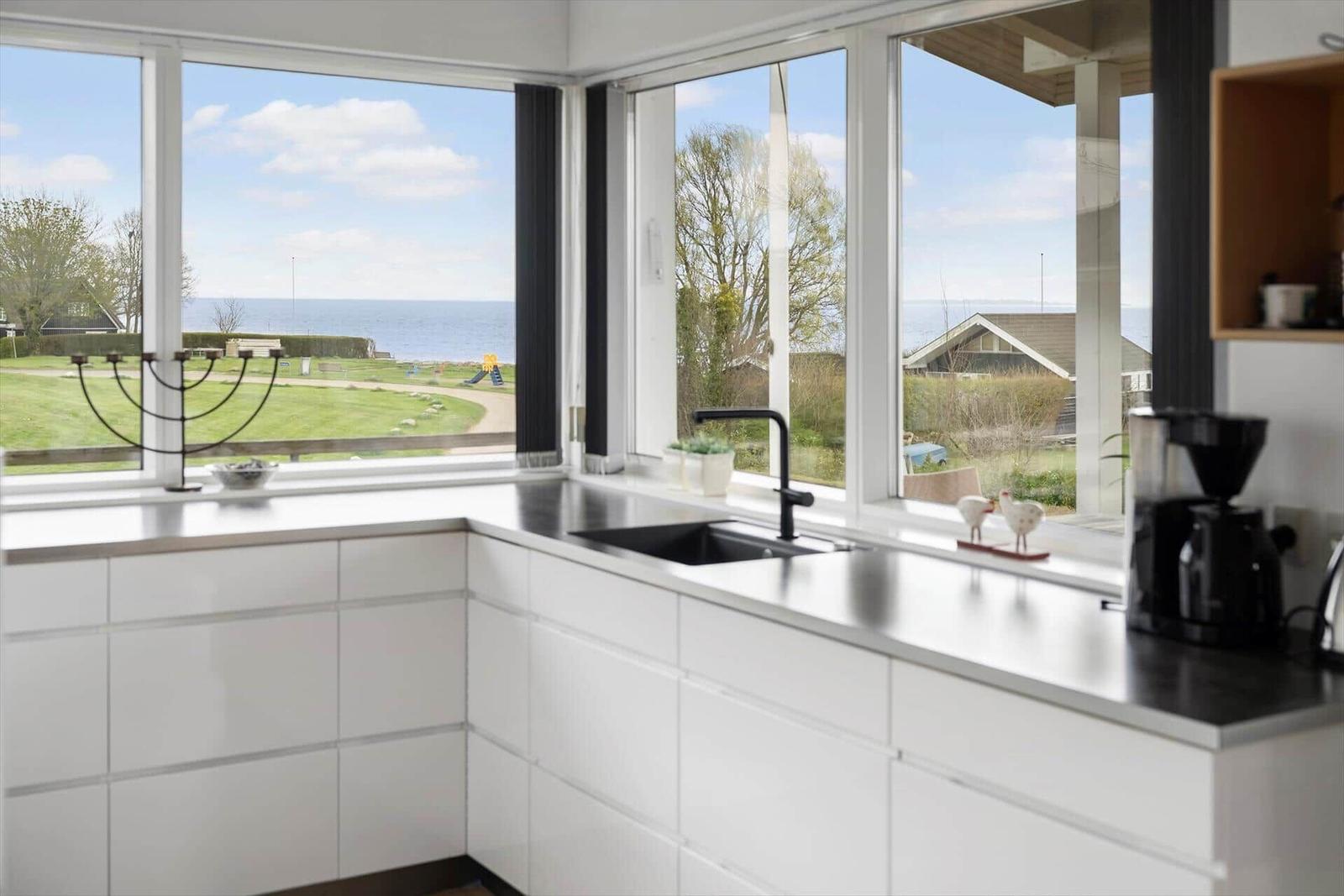 Kitchen with view of the beach and green area