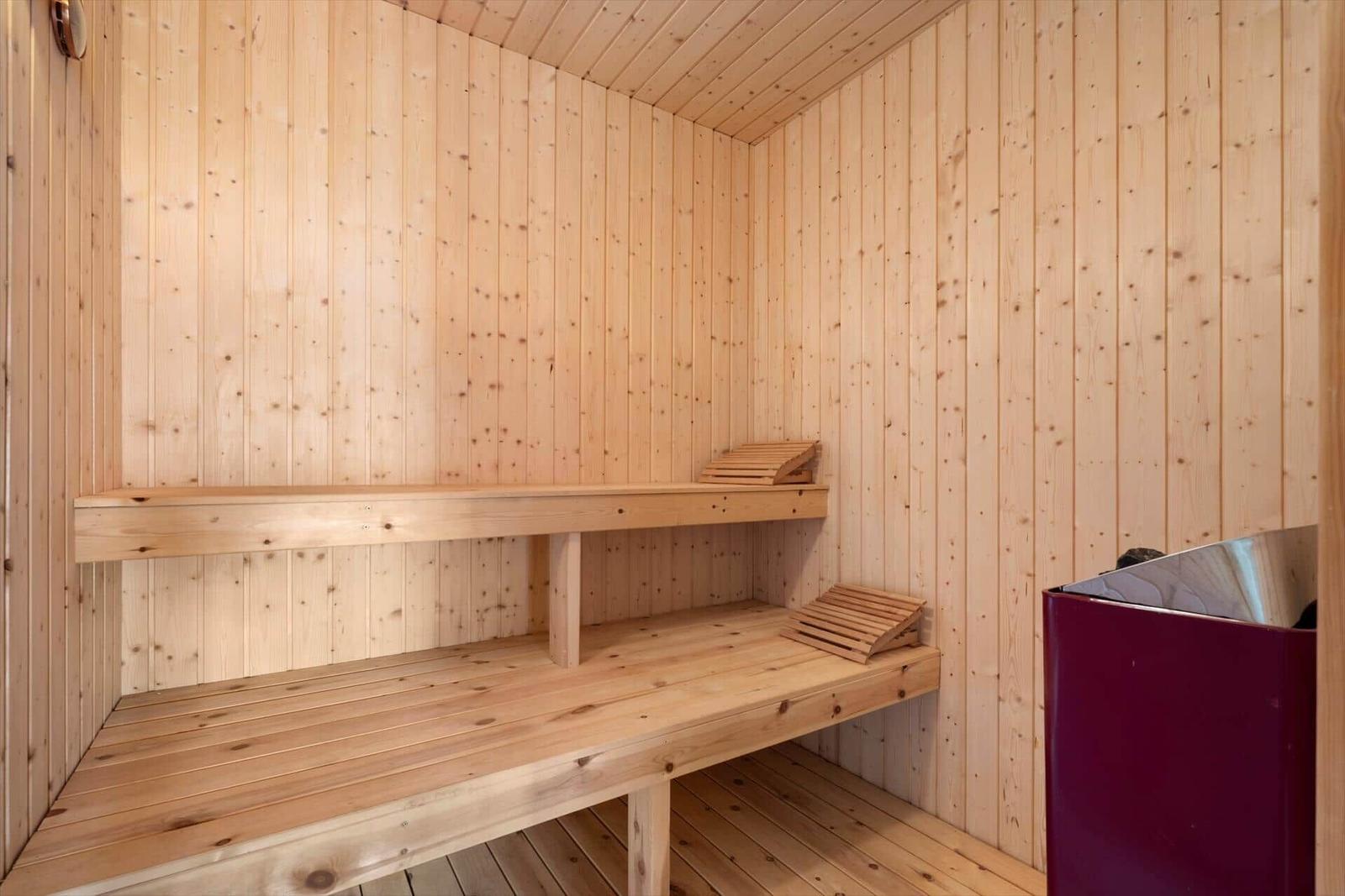 Sauna with wooden paneling and two benches