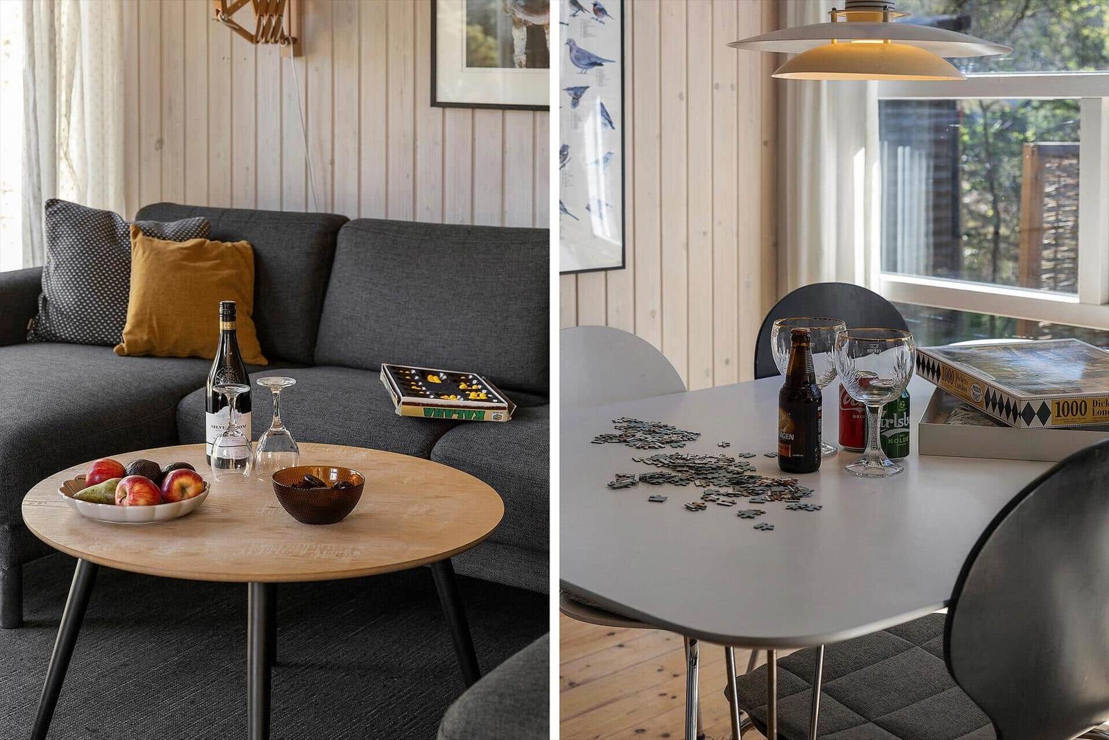 Wohnbereich mit Sofa, Tisch und Obst. Esstisch mit Puzzle und Getränken.