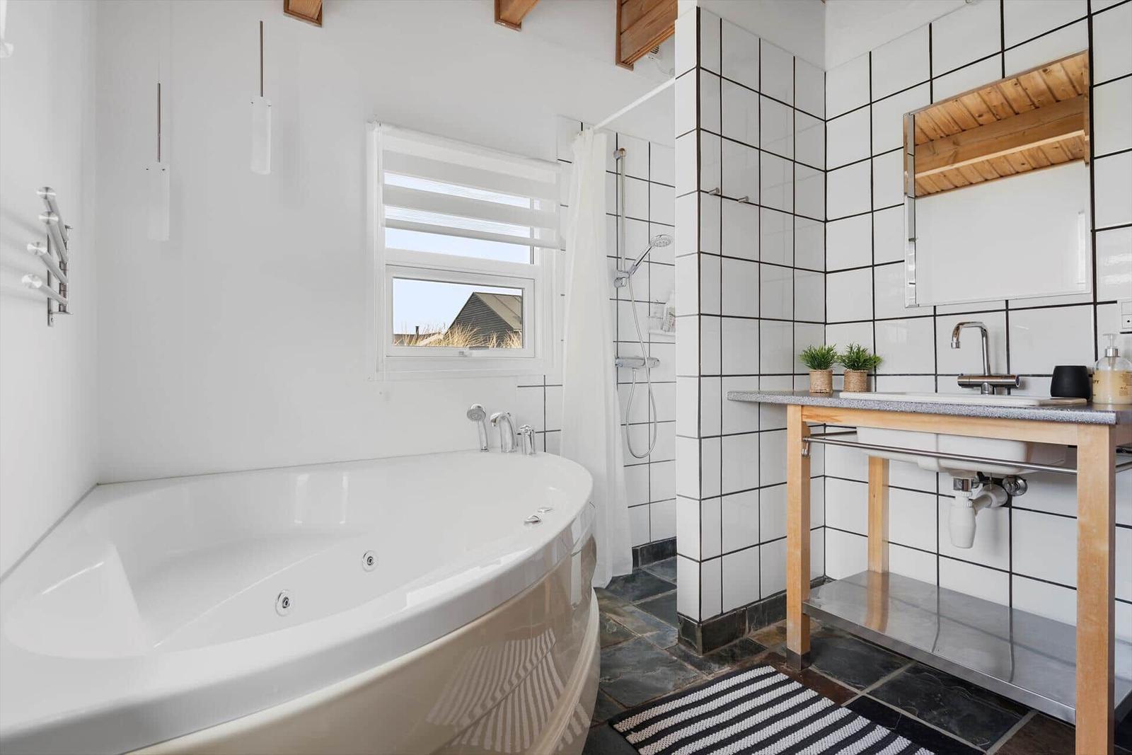 Bath with whirlpool, shower, and sink with mirror