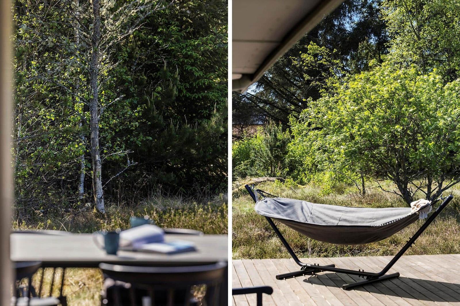 Terrasse mit Tisch und Stühlen, daneben Hängematte im Grünen.