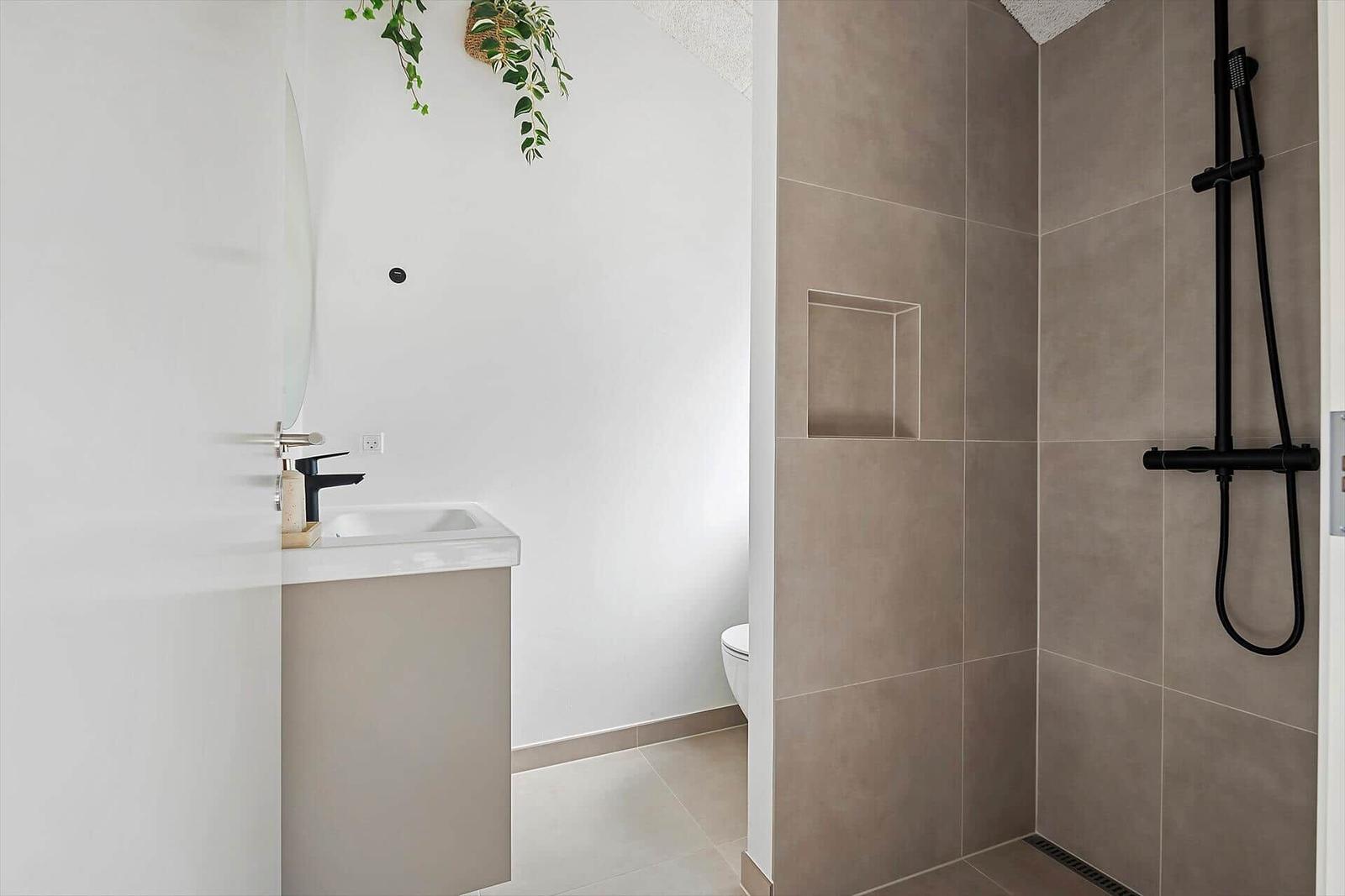Bathroom with shower, sink, and toilet