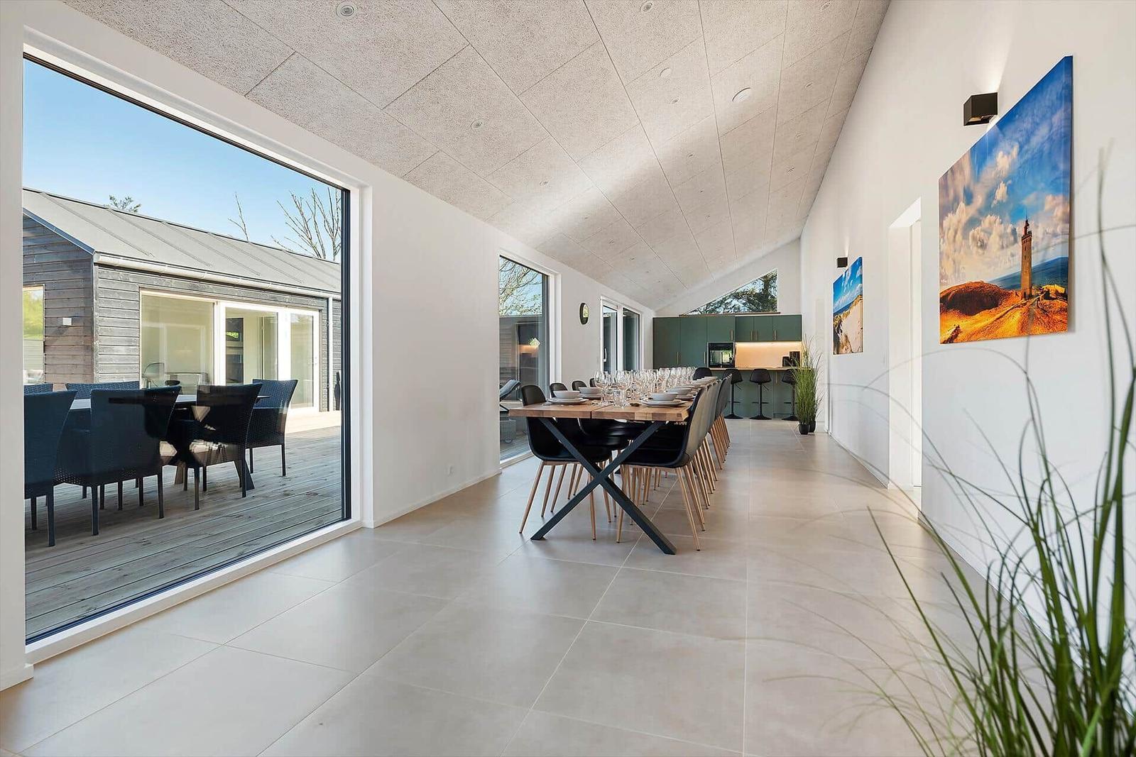 Long space with dining area, large windows, and modern furnishings.