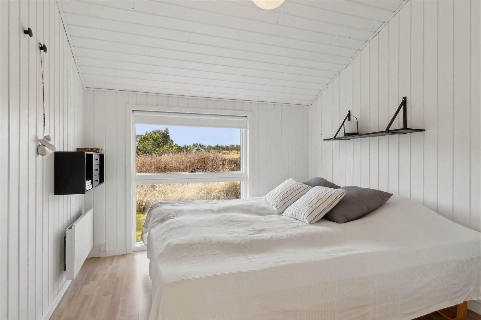Bedroom with bed, window and white walls