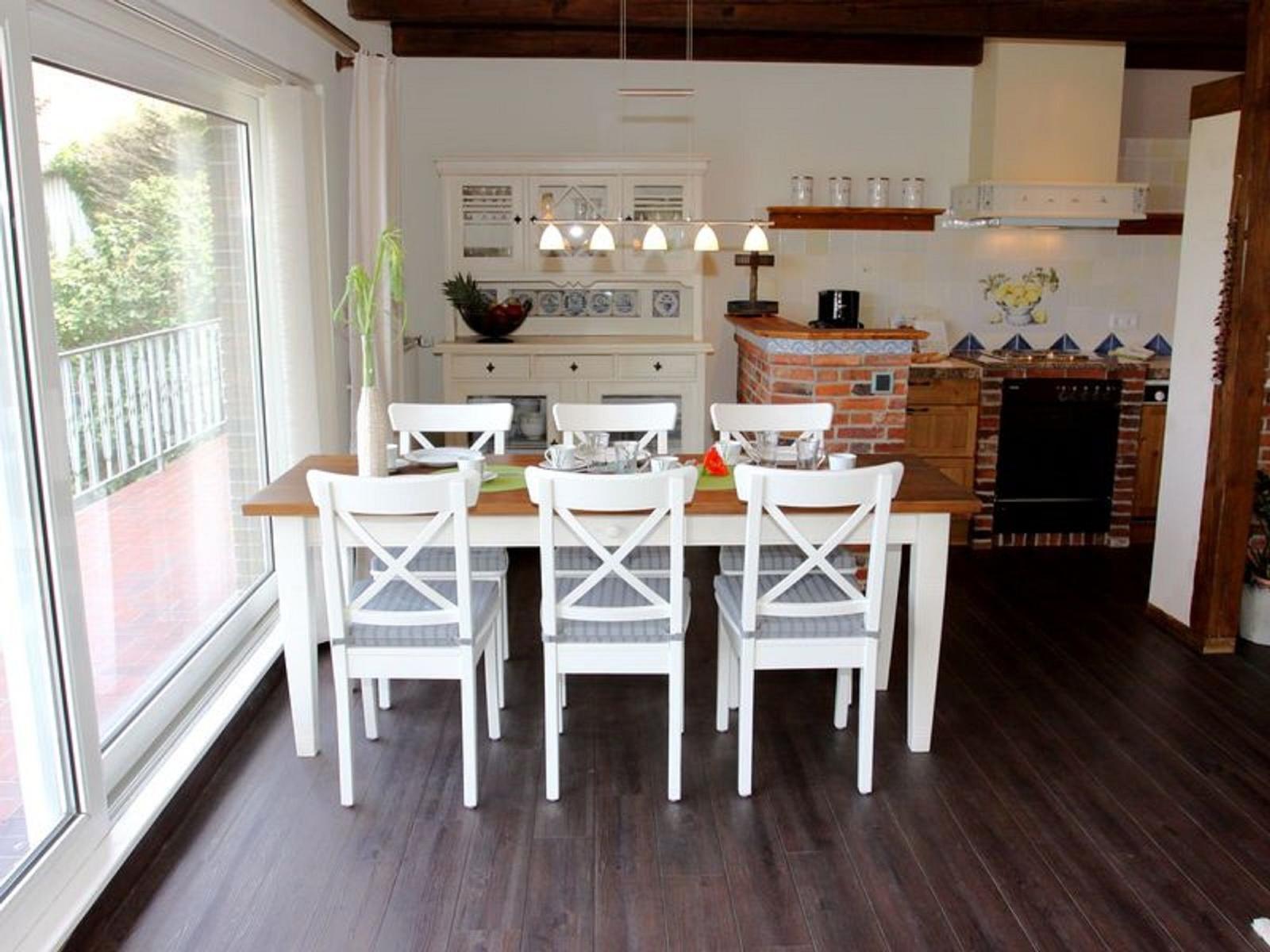 Esszimmer mit Tisch, Stühlen und Blick auf Balkon