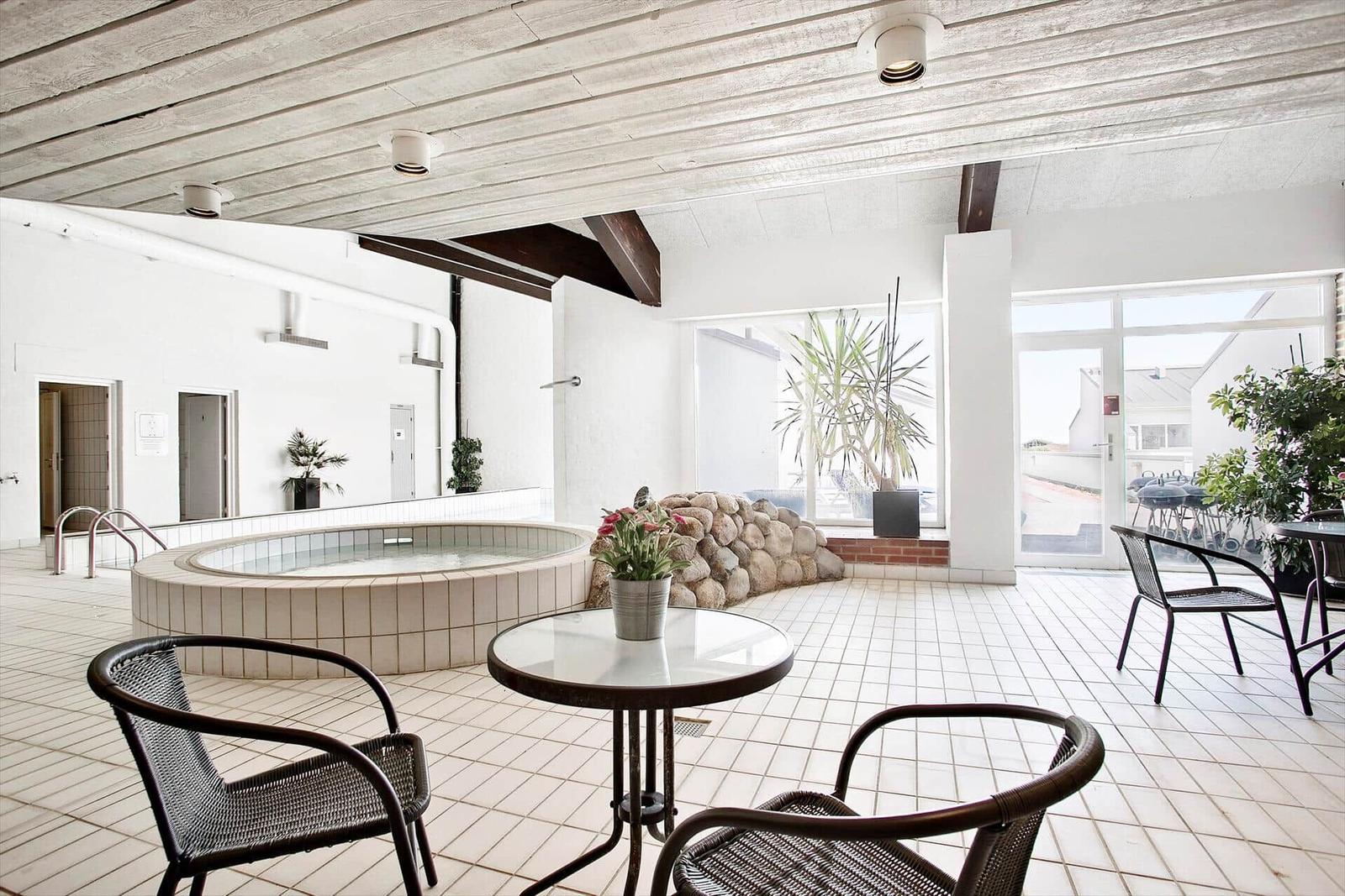 Indoor pool with seating and plants