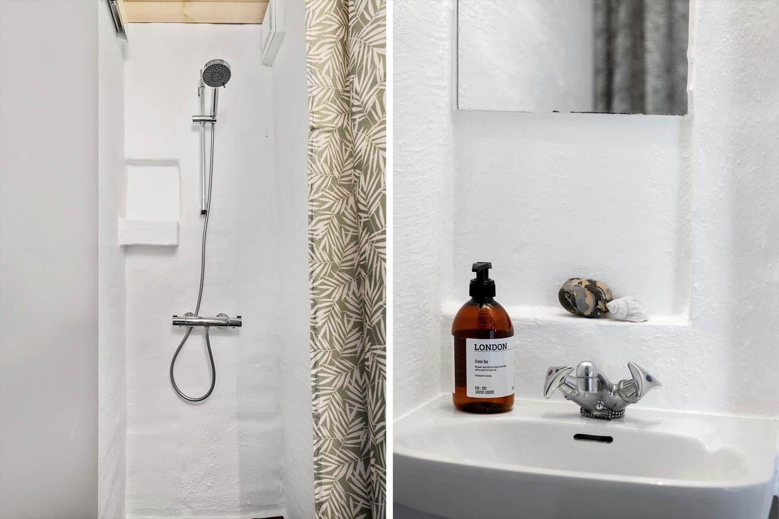 Shower with showerhead and towel holder. Sink with faucet and soap.