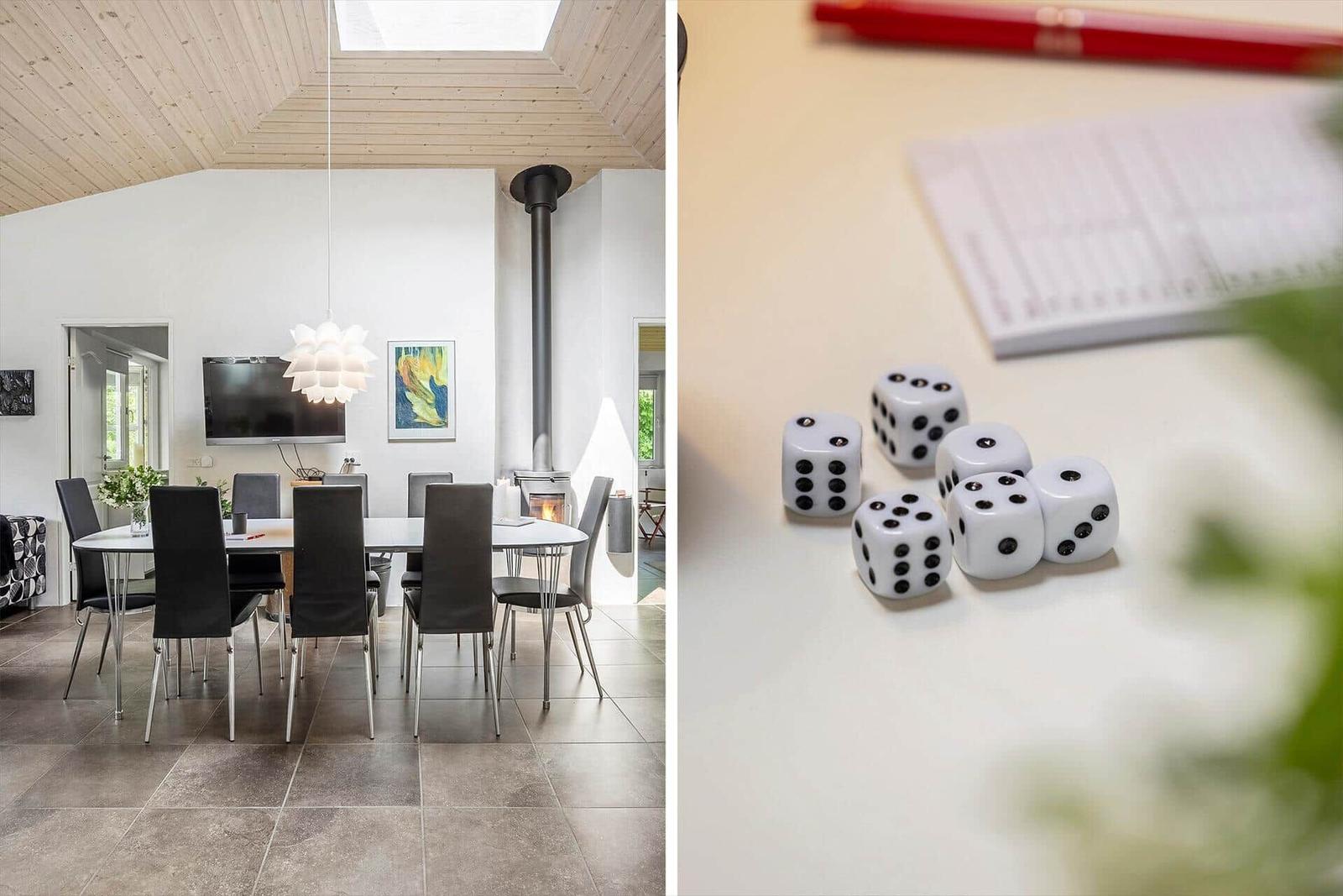 Dining room with table, chairs, and fireplace. Table with dice and notepad.