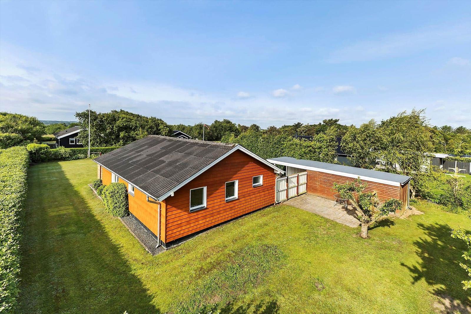 Wooden house with garden and terrace in green surroundings