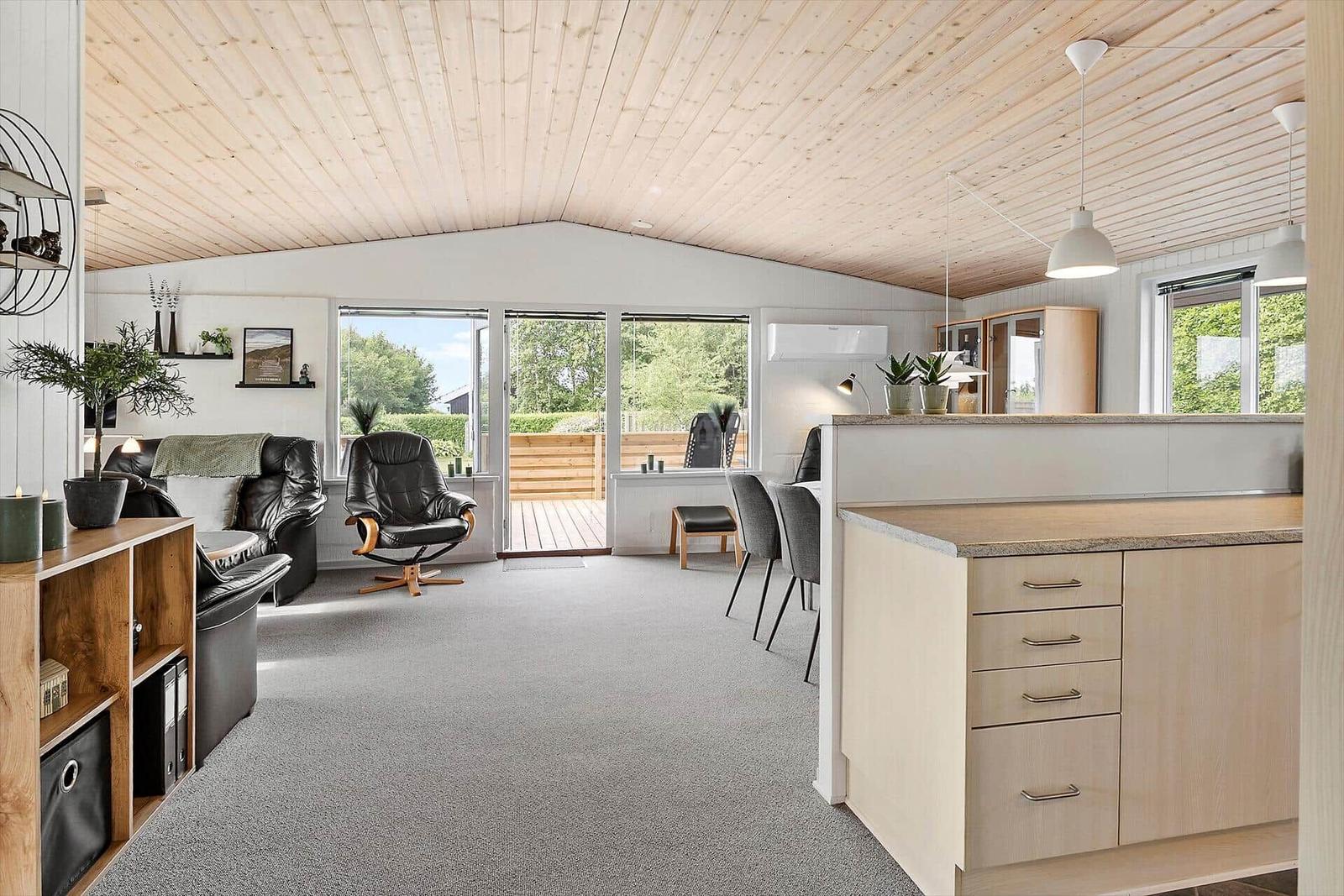 Living and dining area with kitchen island and large window area.