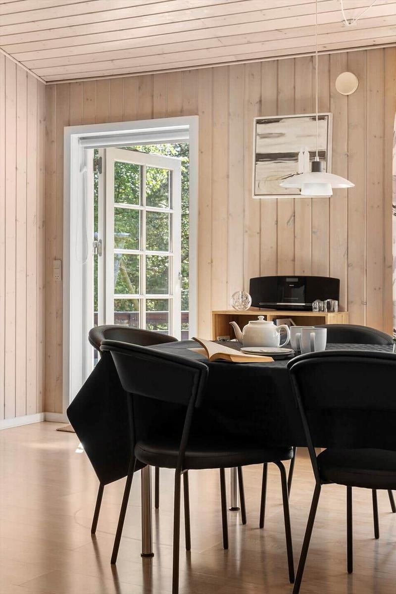 Esszimmer mit Tisch, Stühlen und Fenster zur Außenseite.
