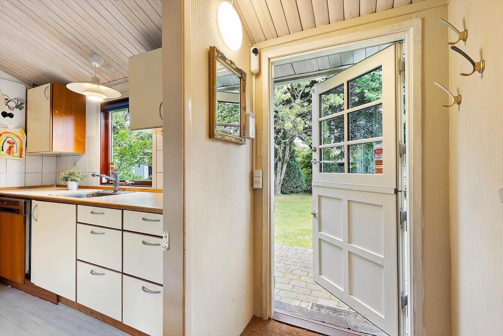 Kitchen with view of garden. Door leads outside.