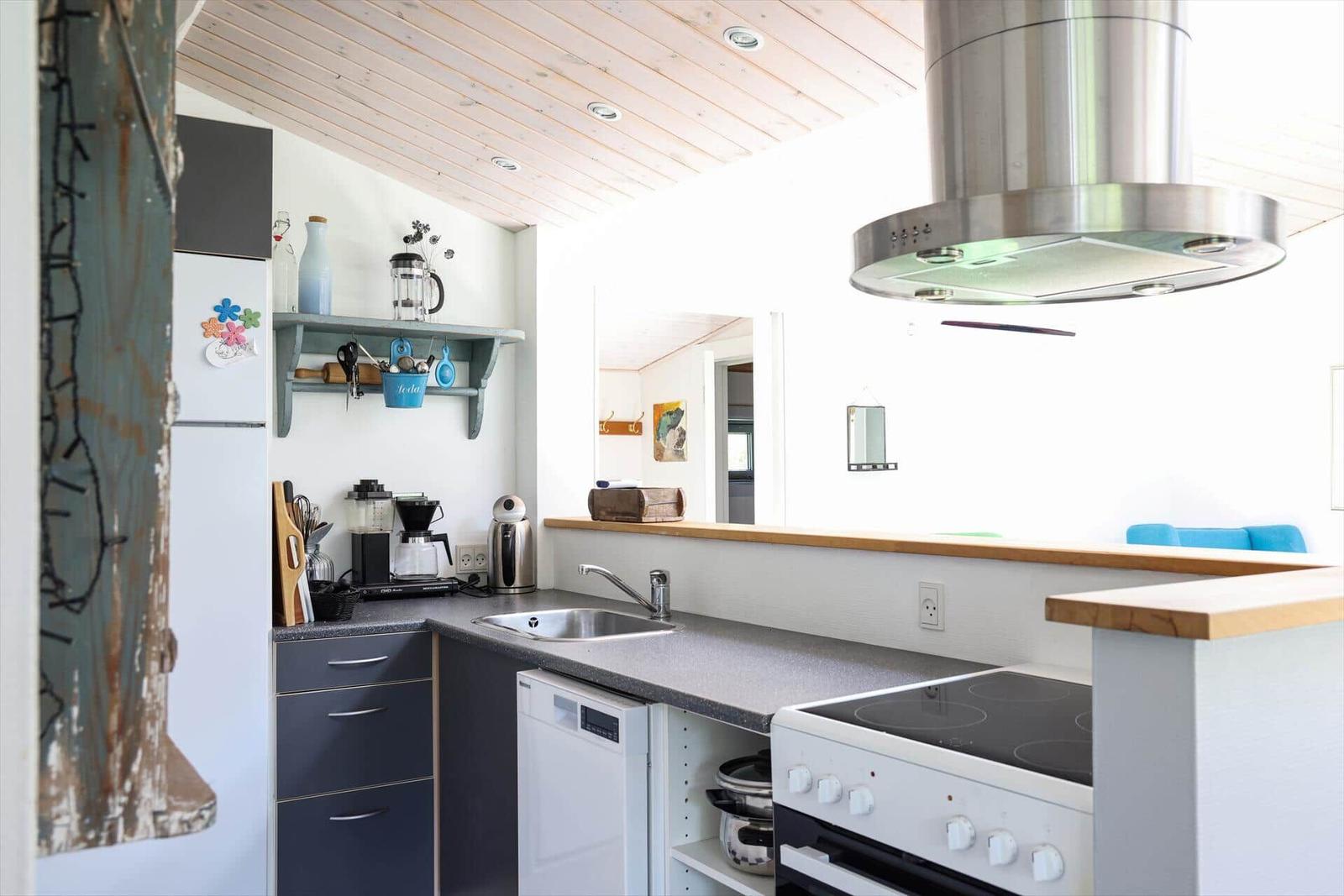 Kitchen with stainless steel stove, sink, and countertop.