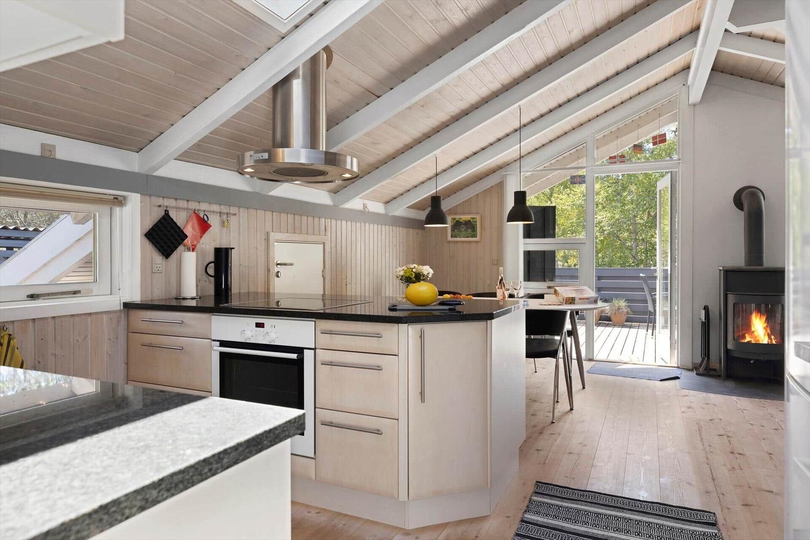 Kitchen with dining area, fireplace, and view of terrace