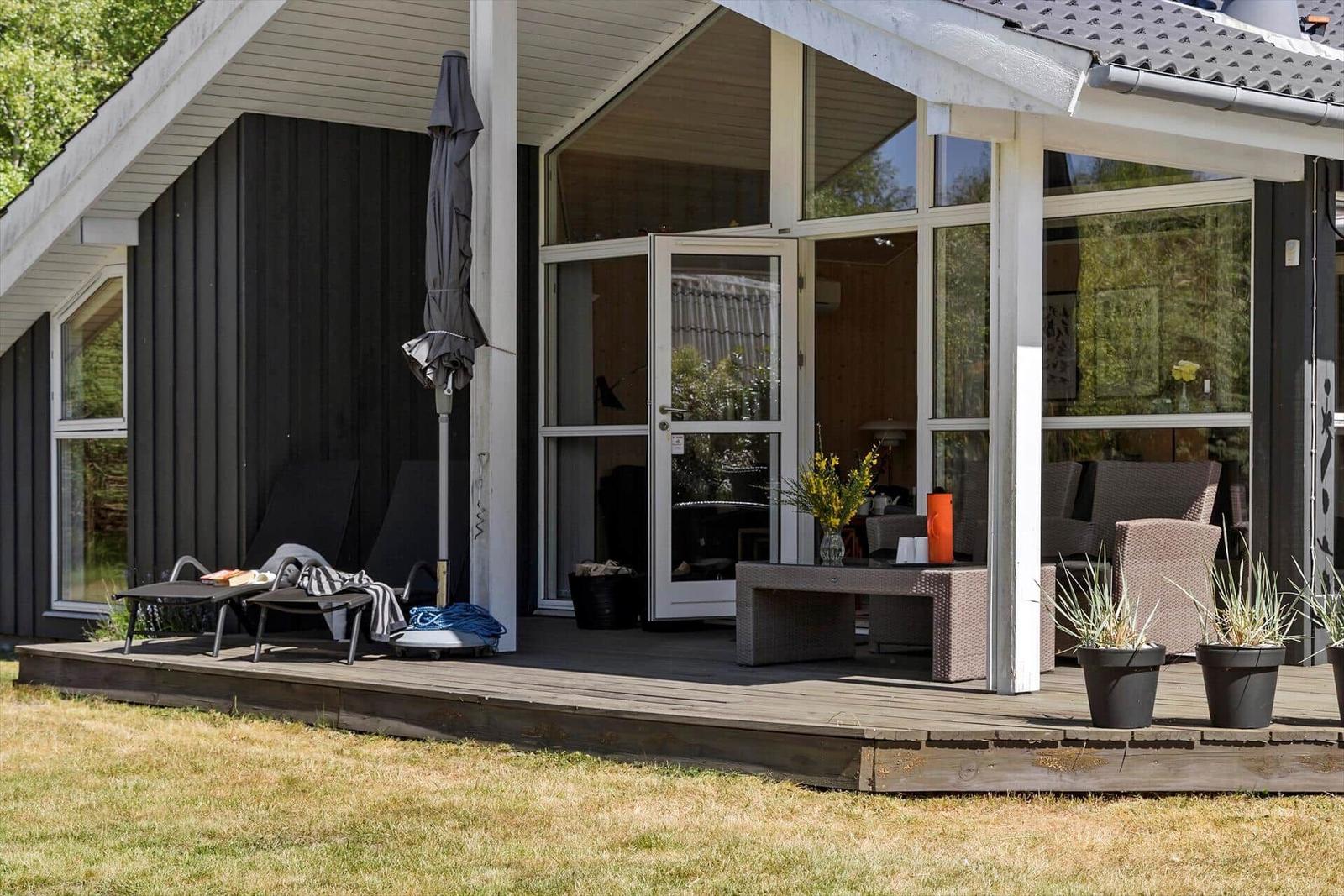 Deck with garden furniture and view into the house.
