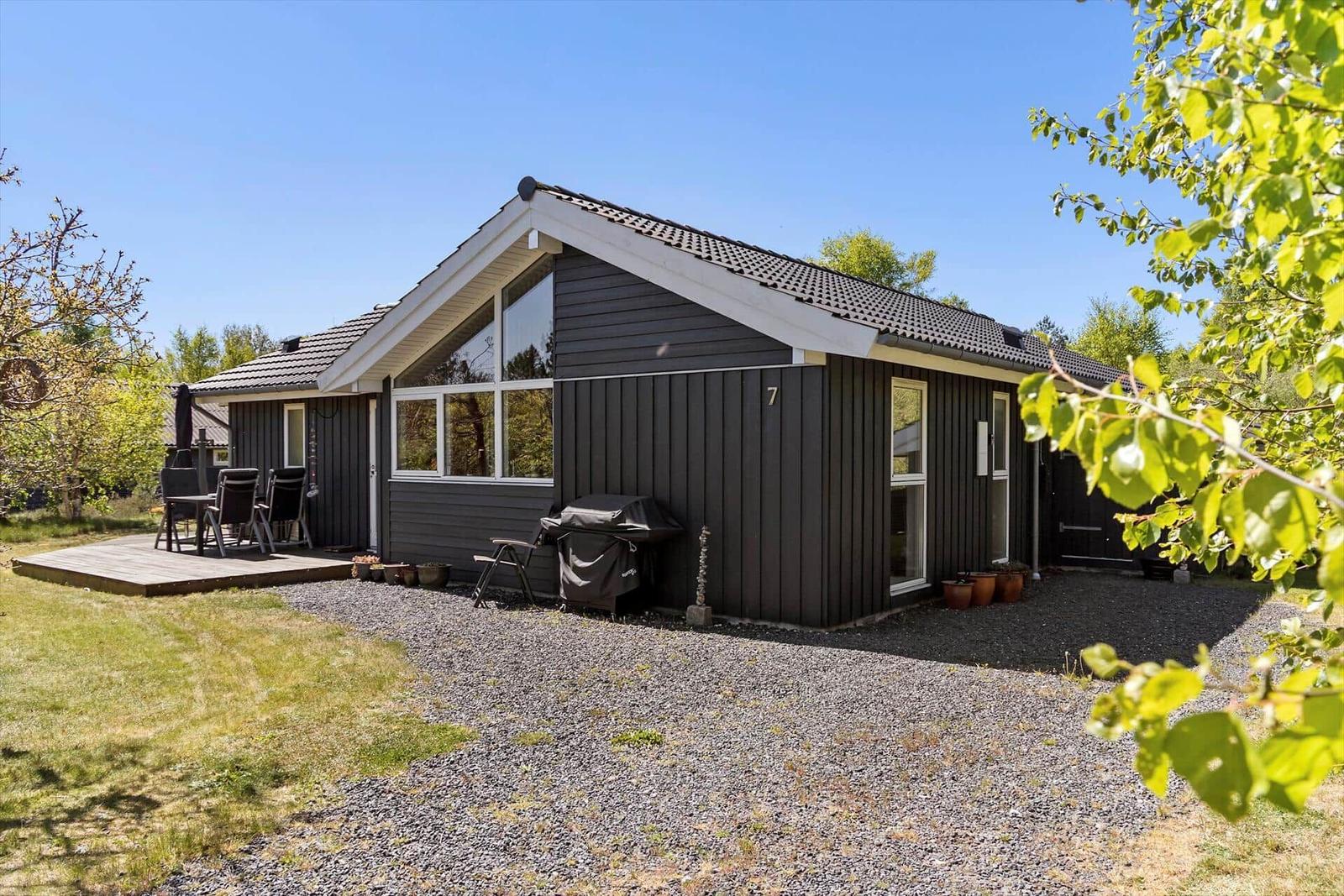 Modern holiday home with terrace and grill area in the green.