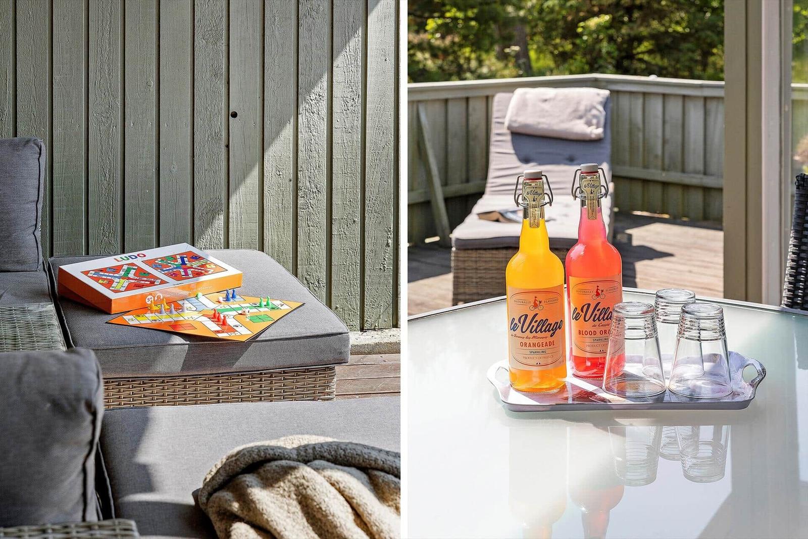 Outdoor area with game and drinks on table and sofa.