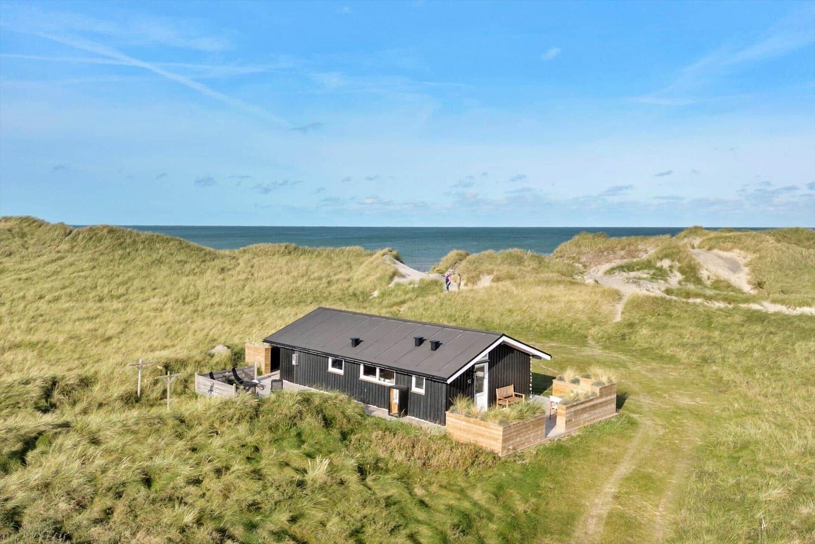 A simple house on dunes with sea view and terrace.