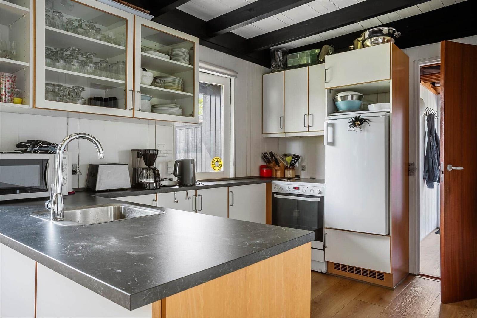 Kitchen with countertop, sink, refrigerator, and stove.