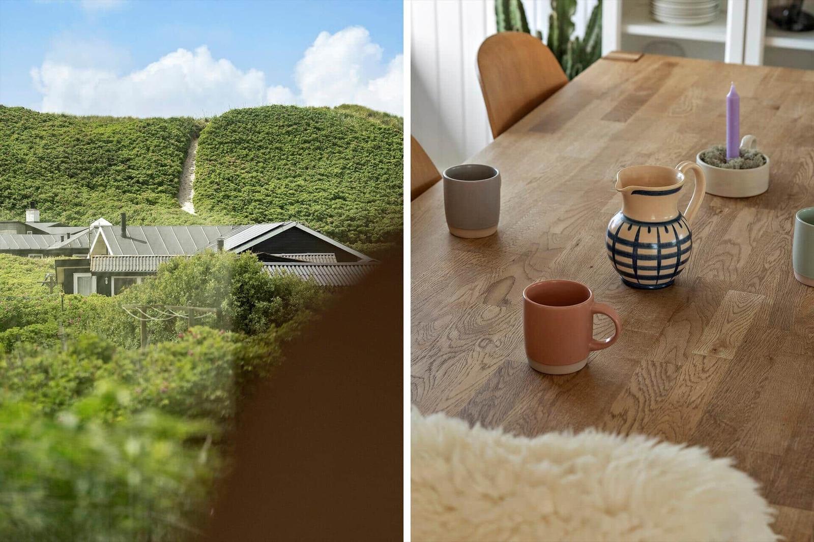 Haus mit grüner Hügellandschaft und rustikalem Holztisch mit Tassen und Kerze.