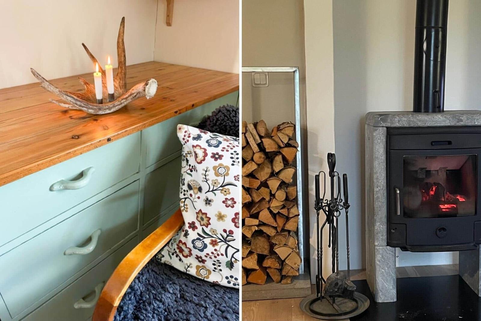 Holzofen mit Brennholz und Feuerzeugset. Holzoberfläche mit Kerzen und Geweih.