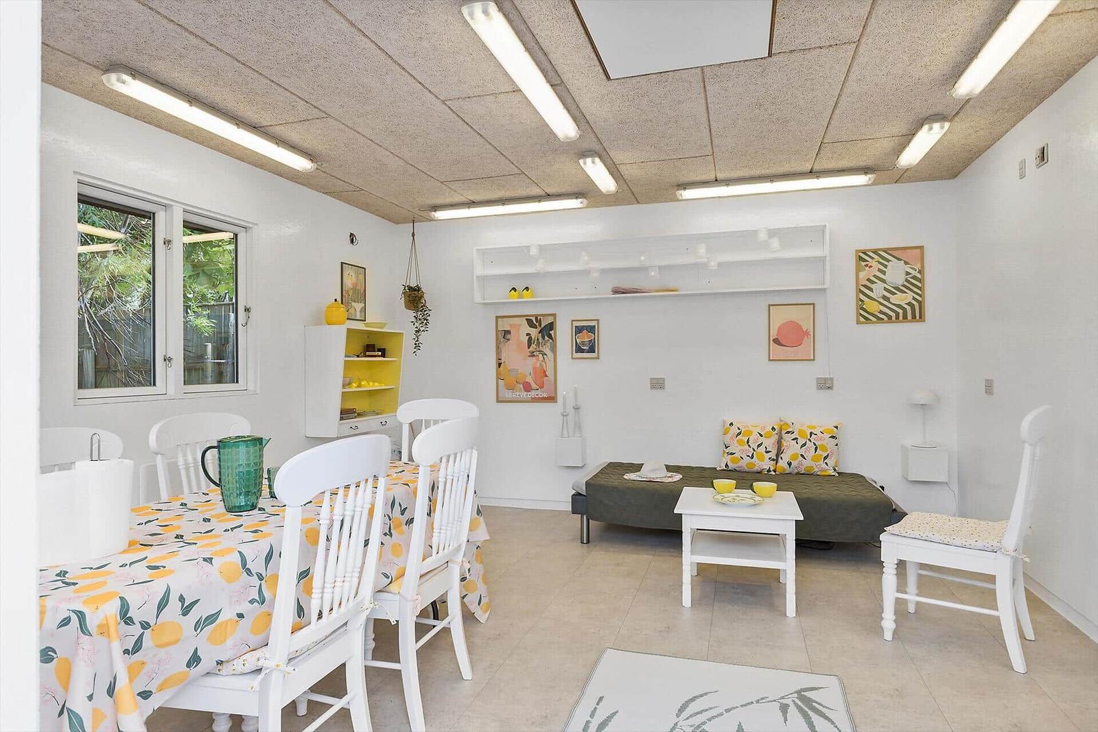 Dining area with table and chairs. Living area with sofa and table.