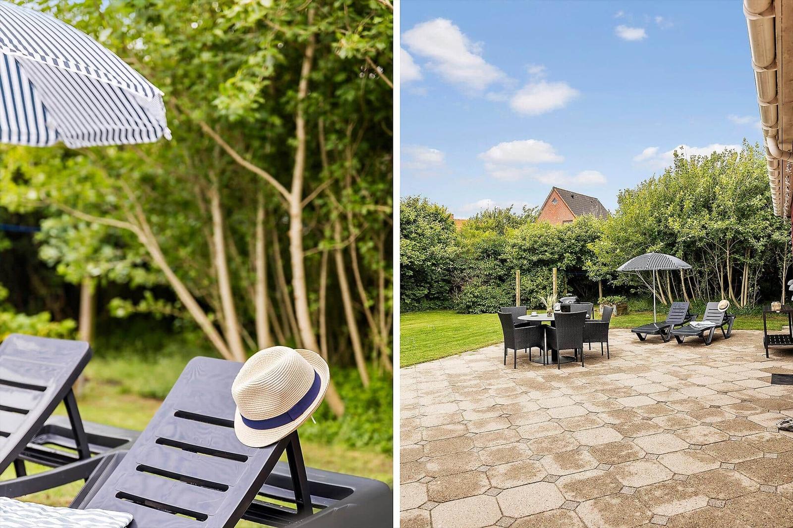 Terrace with lounge chairs, parasol, and grill area in the garden.