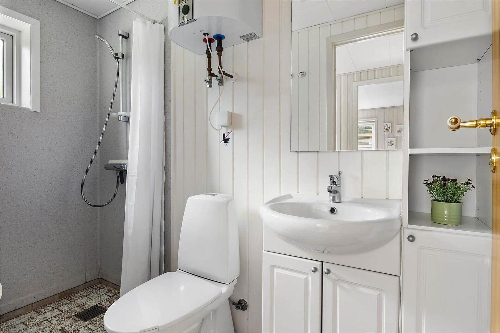 Bathroom with toilet, sink, and shower
