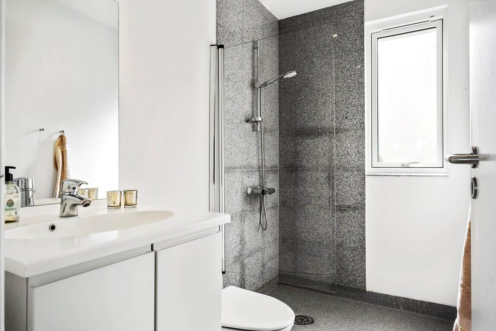 Bathroom with shower, sink, and toilet.